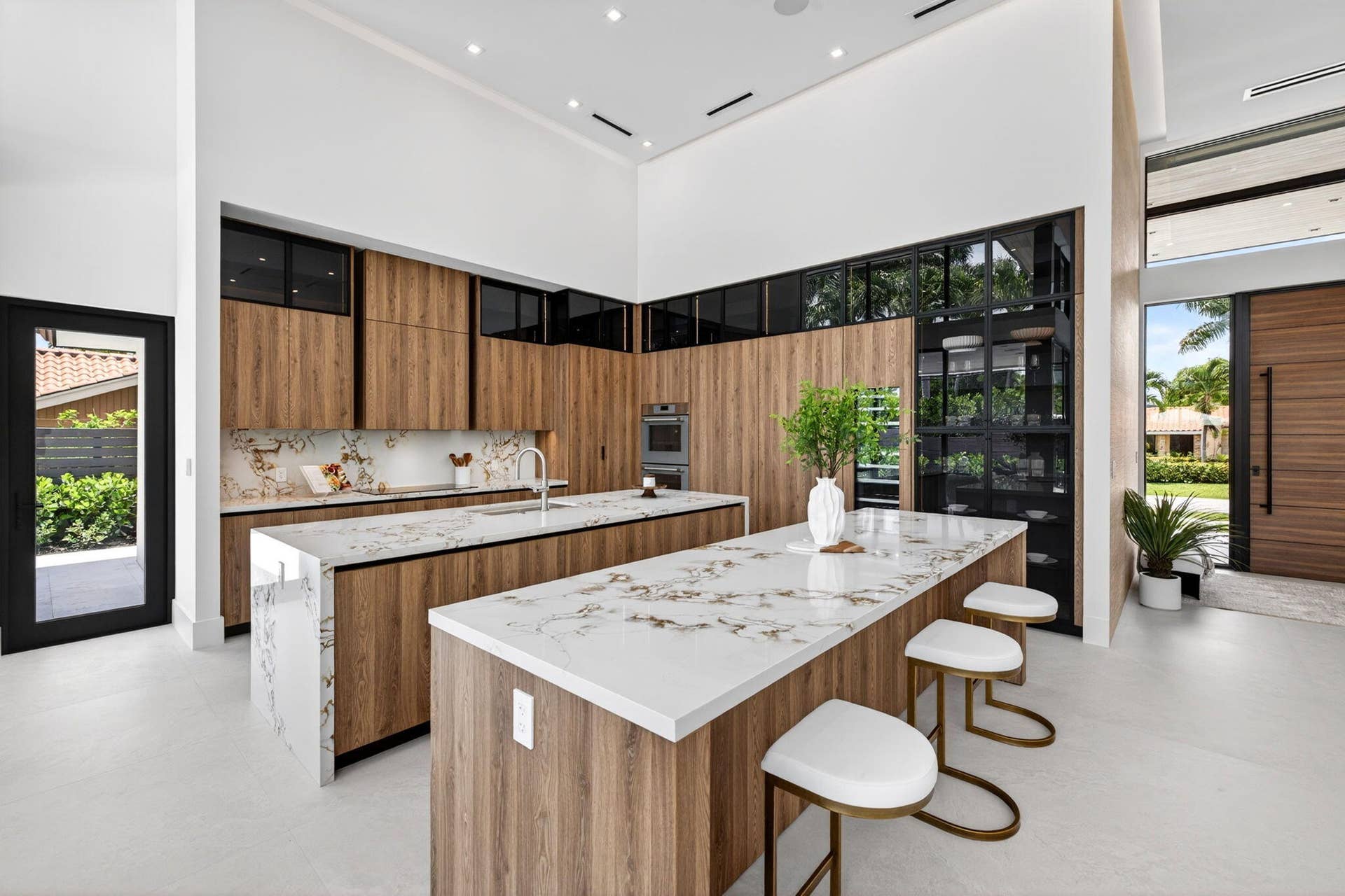 2717 NE 33rd Street, Fort Lauderdale, FL 33306 The kitchen combines sculptural design and daily function with premium appliances, custom storage, and polished modern finishes.