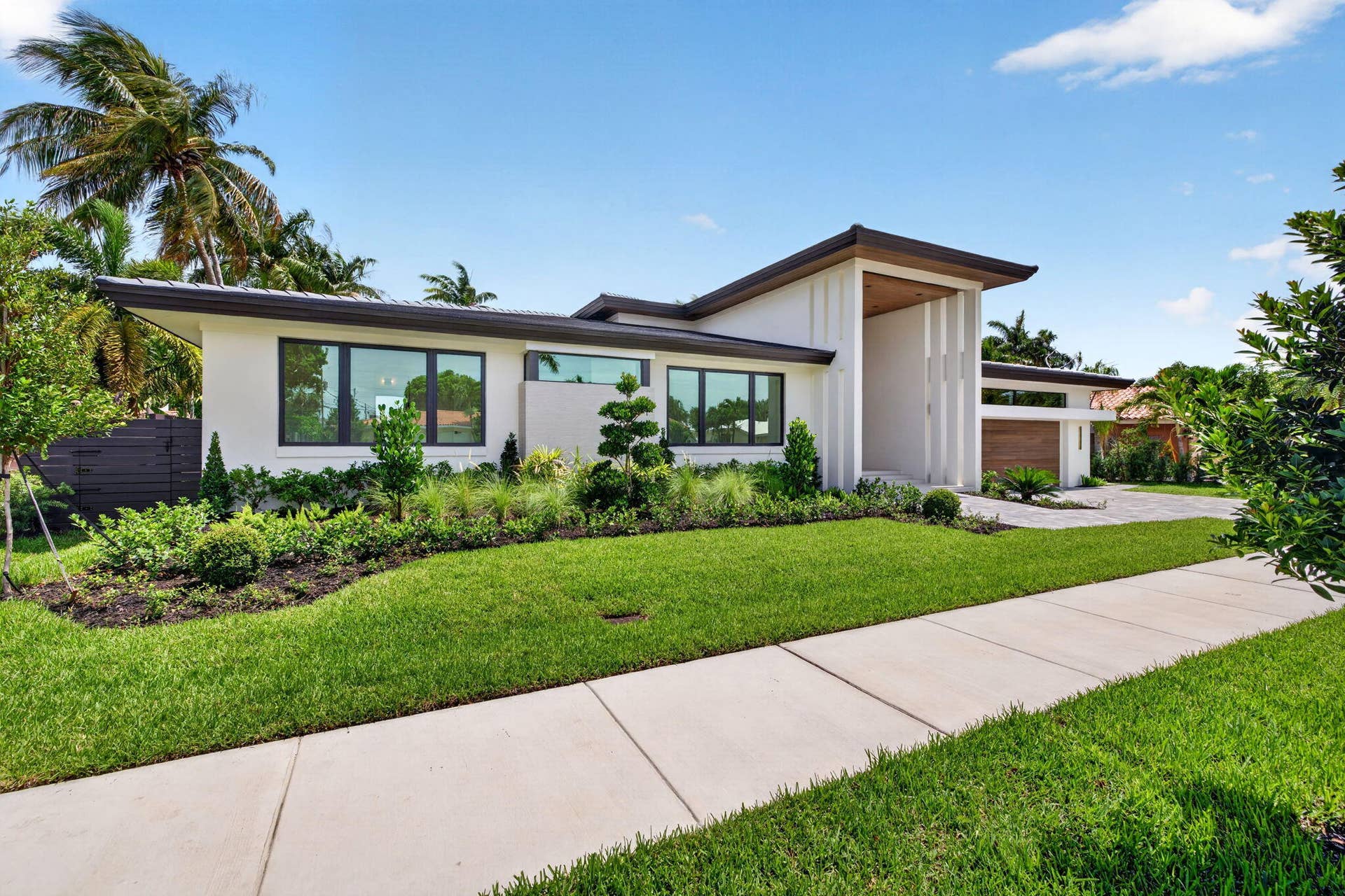 2717 NE 33rd Street, Fort Lauderdale, FL 33306 Modern single-story architecture creates strong curb appeal with a refined entry sequence and manicured Fort Lauderdale setting.