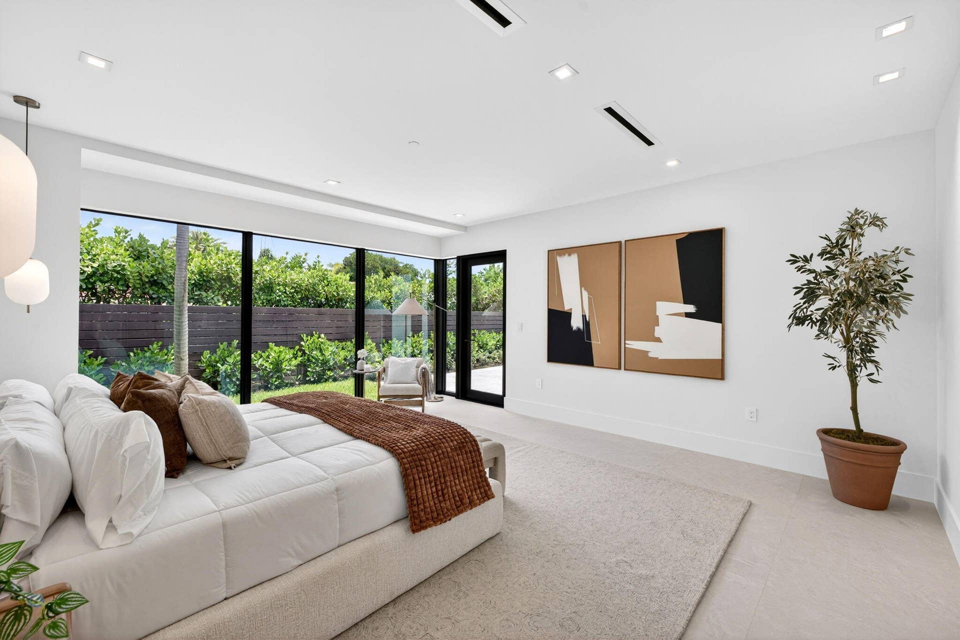 2717 NE 33rd Street, Fort Lauderdale, FL 33306 The primary suite offers a serene retreat with garden views, soft natural light, and a calm luxury sensibility.