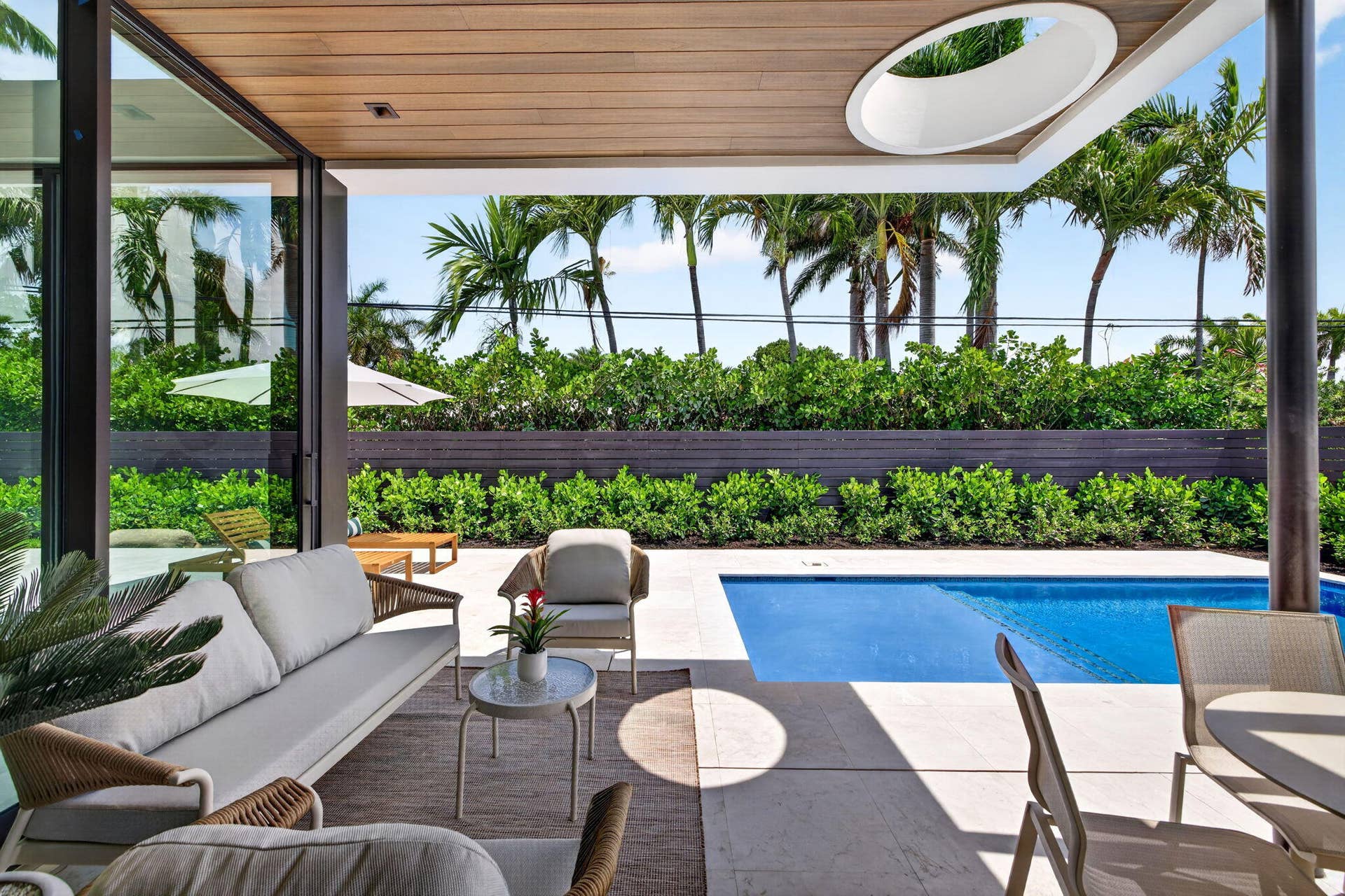 2717 NE 33rd Street, Fort Lauderdale, FL 33306 A resort-style patio setting connects the interiors to the pool, landscaping, and year-round open-air living.