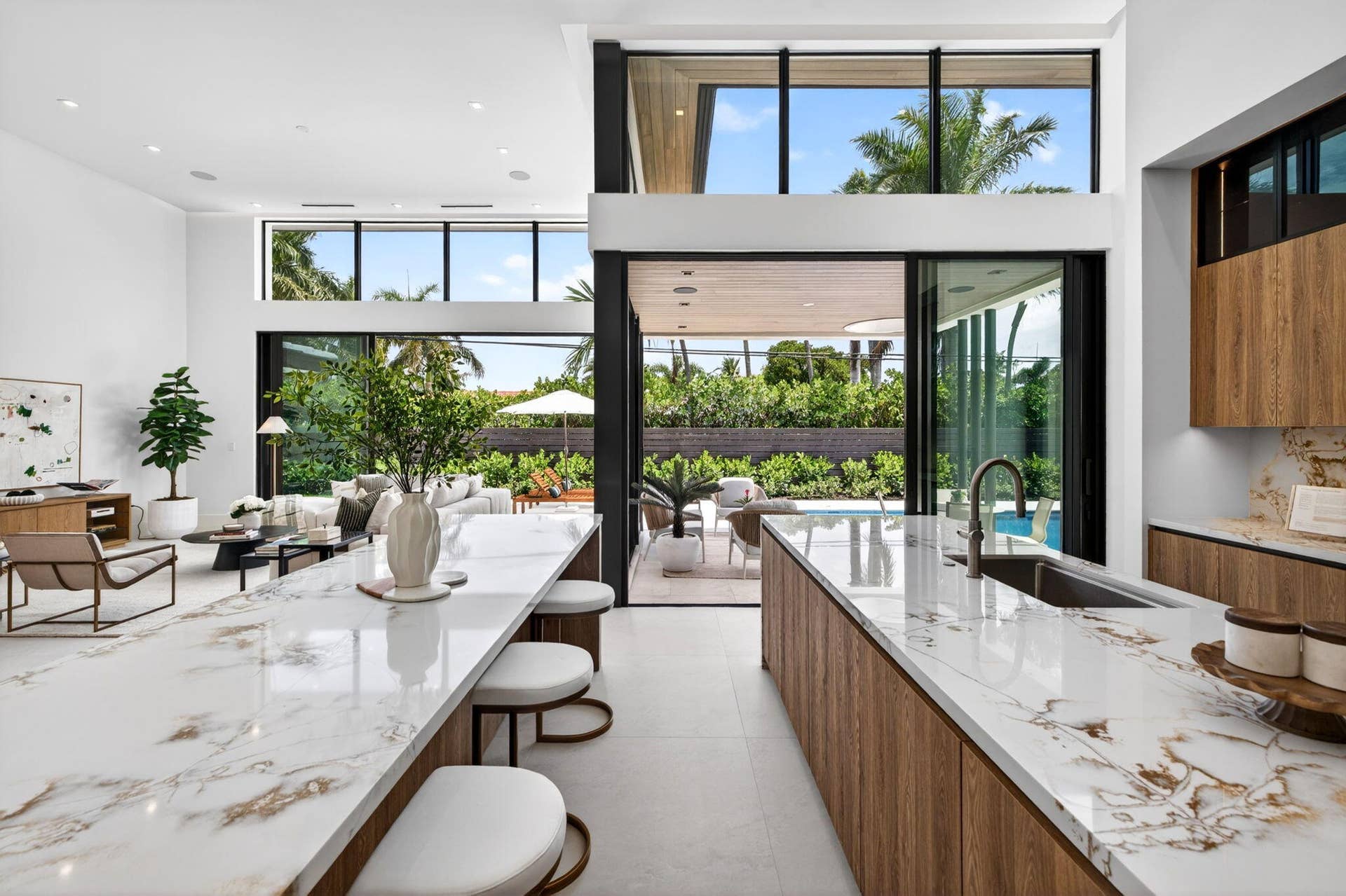2717 NE 33rd Street, Fort Lauderdale, FL 33306 An open interior perspective captures the home's airy scale, refined material palette, and effortless single-story living.