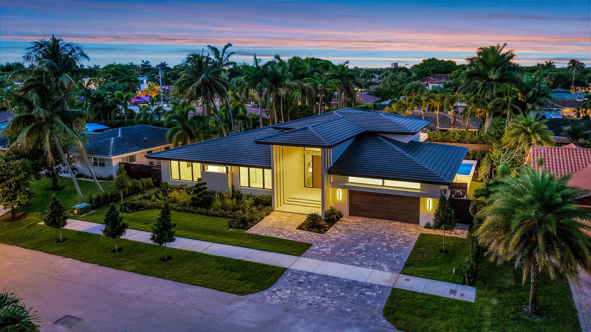 2717 NE 33rd Street, Fort Lauderdale, FL 33306 Modern single-story architecture creates strong curb appeal with a refined entry sequence and manicured Fort Lauderdale setting.