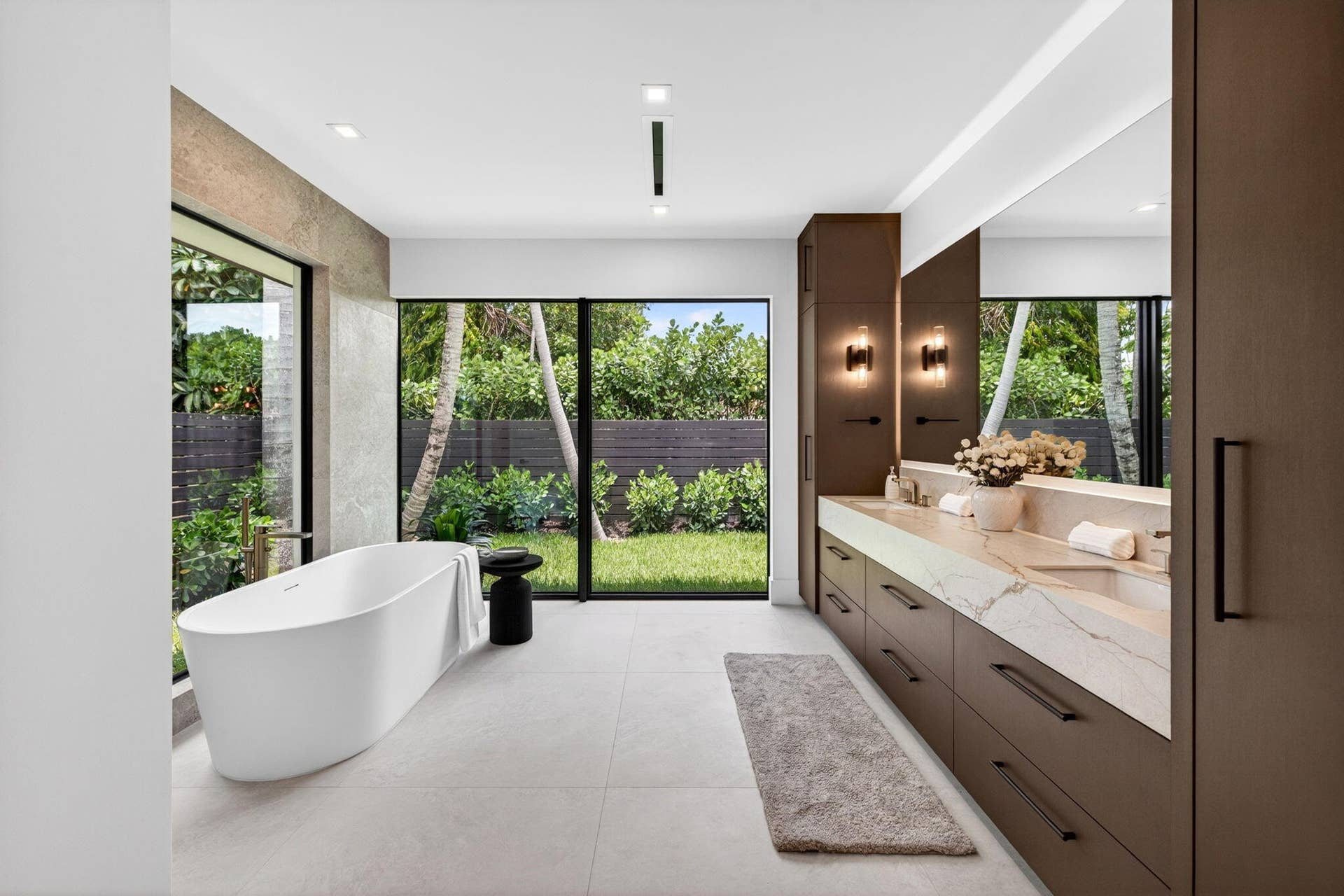 2717 NE 33rd Street, Fort Lauderdale, FL 33306 Spa-inspired bath finishes create a quiet luxury experience with sleek vanities, glass, stone, and tranquil garden outlooks.
