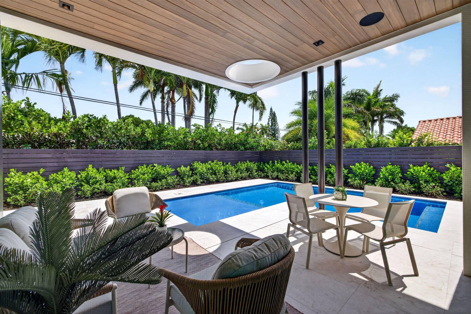 2717 NE 33rd Street, Fort Lauderdale, FL 33306 The outdoor living areas are designed for relaxed South Florida entertaining with shaded seating, pool views, and privacy.