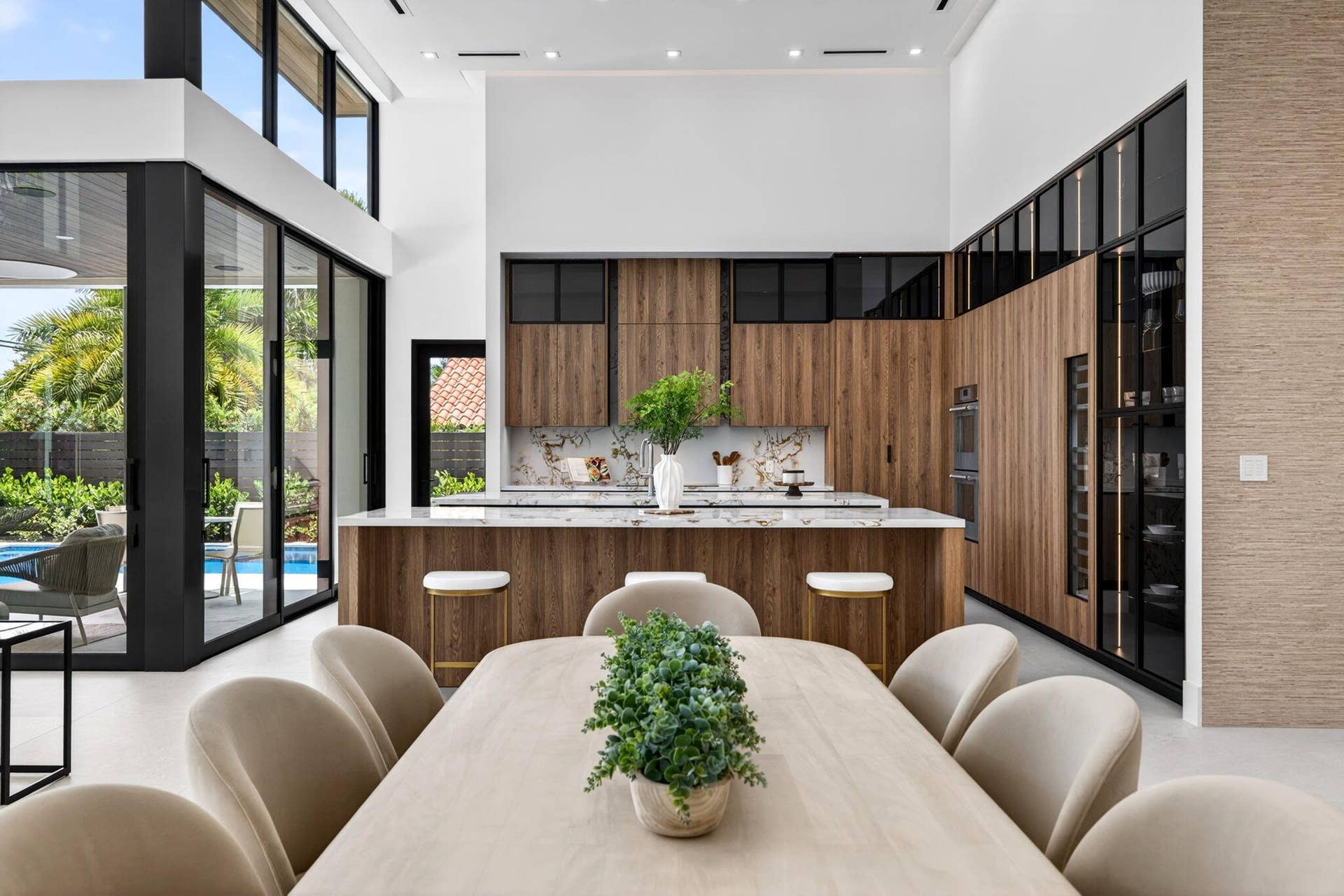 2717 NE 33rd Street, Fort Lauderdale, FL 33306 A refined kitchen view highlights generous prep areas, warm cabinetry, elegant stone surfaces, and strong indoor-outdoor flow.