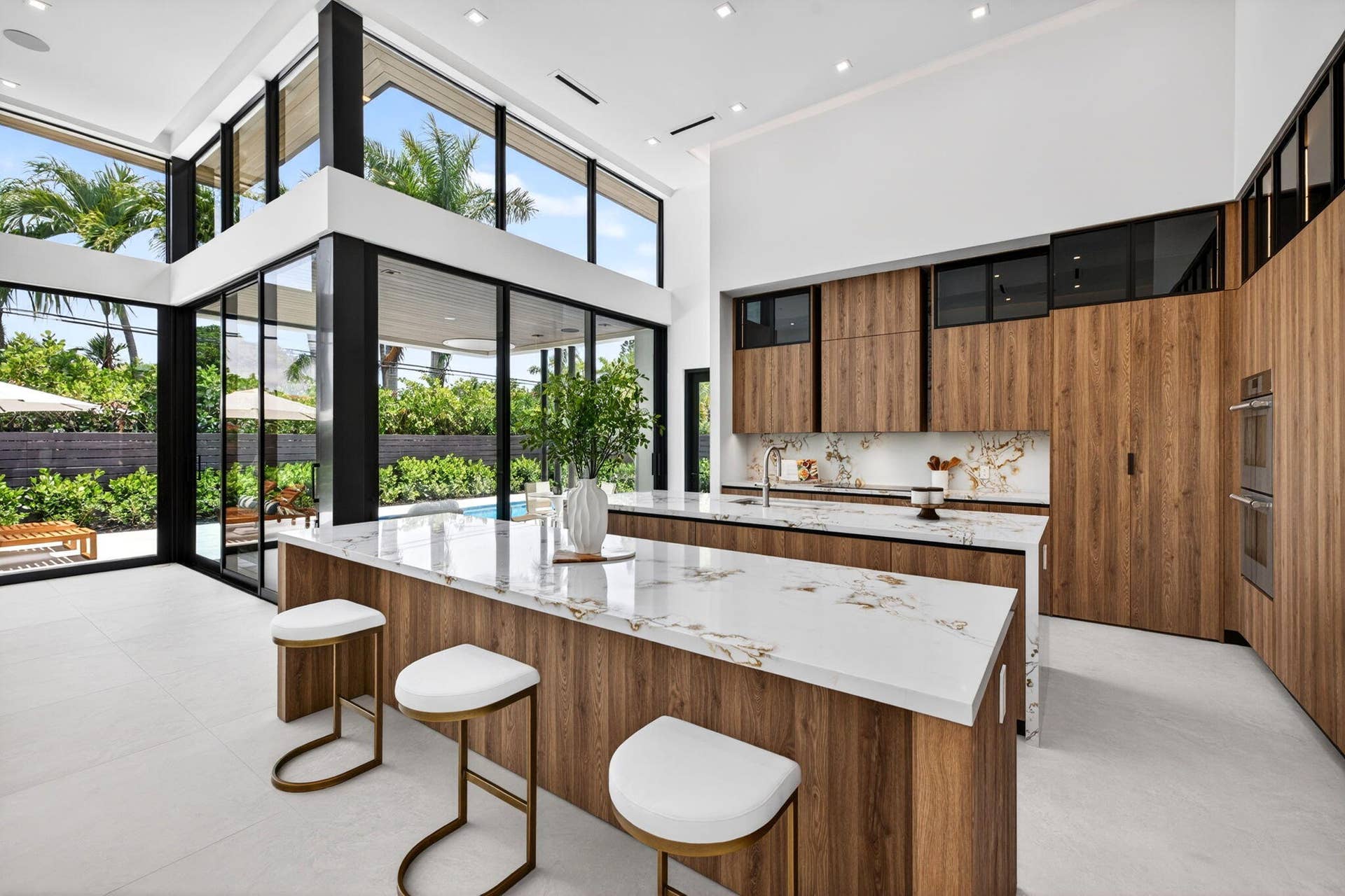 2717 NE 33rd Street, Fort Lauderdale, FL 33306 The kitchen combines sculptural design and daily function with premium appliances, custom storage, and polished modern finishes.