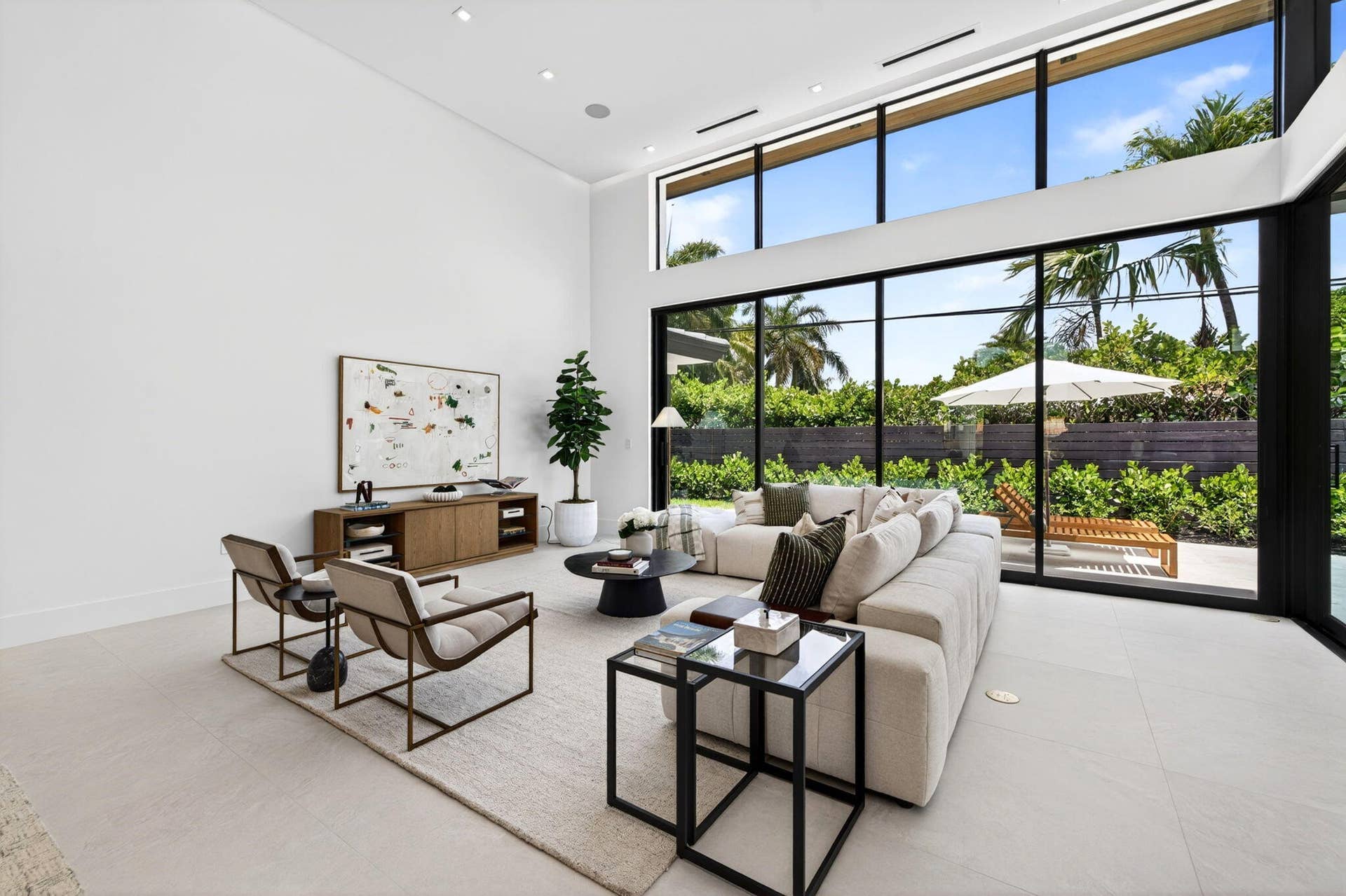 2717 NE 33rd Street, Fort Lauderdale, FL 33306 An open interior perspective captures the home's airy scale, refined material palette, and effortless single-story living.