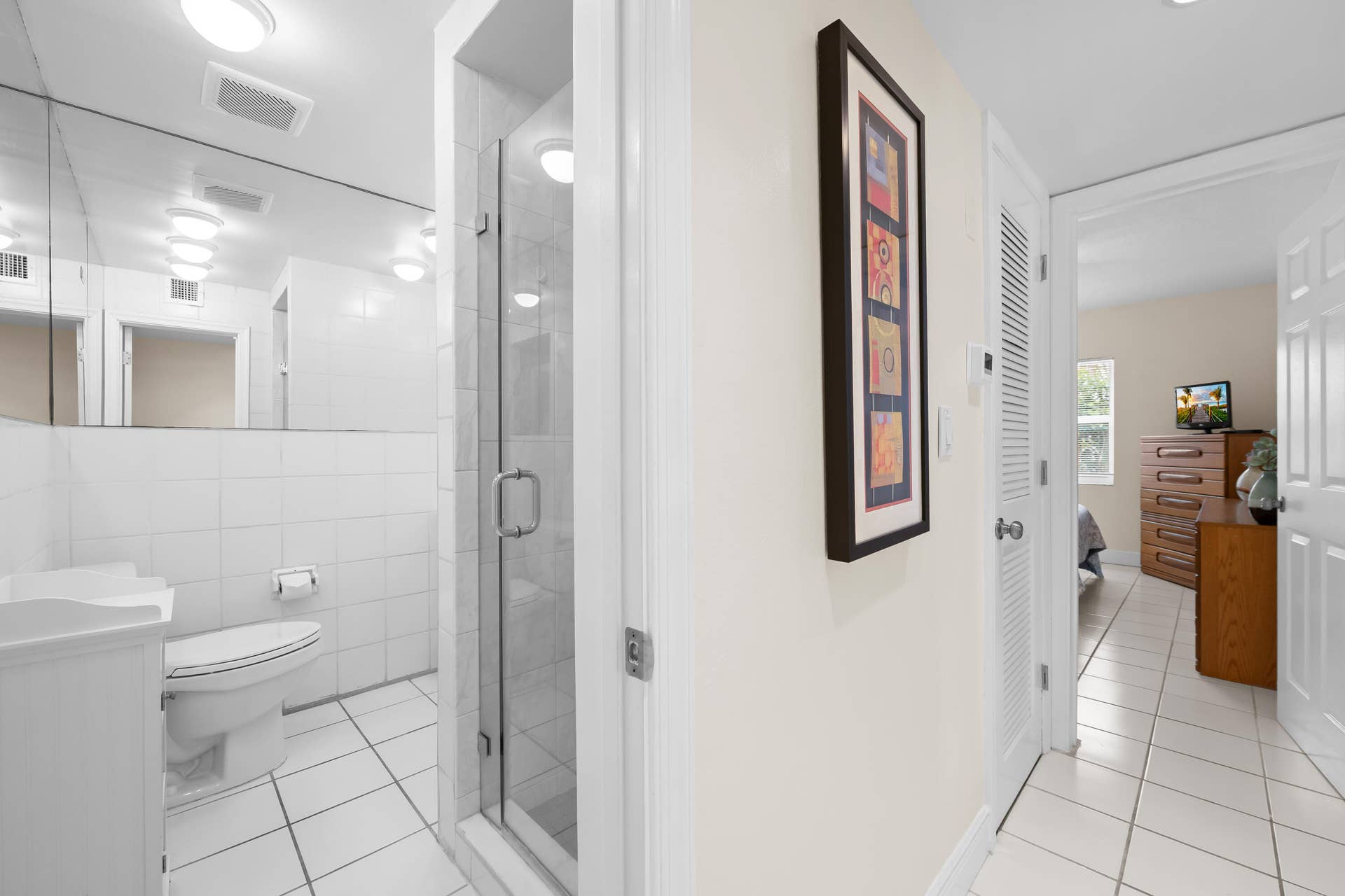 Hallway with bathroom and bedroom view
