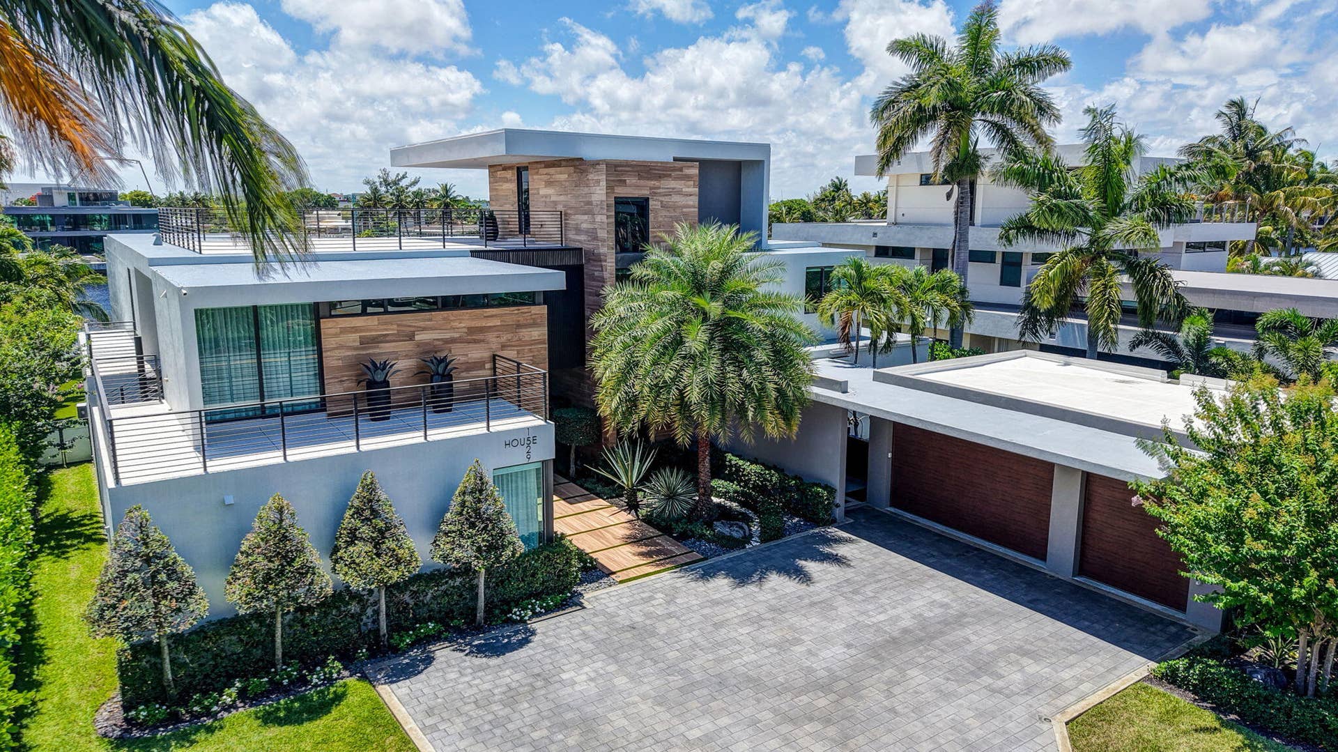 A memorable arrival experience defined by contemporary architecture, tropical landscaping, gated privacy, and an impressive motor court.