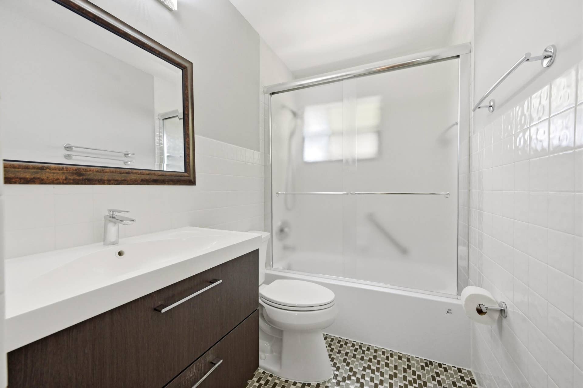 905 NE 28th Street, #206, Wilton Manors, FL 33334 Beautifully remodeled upstairs bathroom featuring a tub and shower combination.