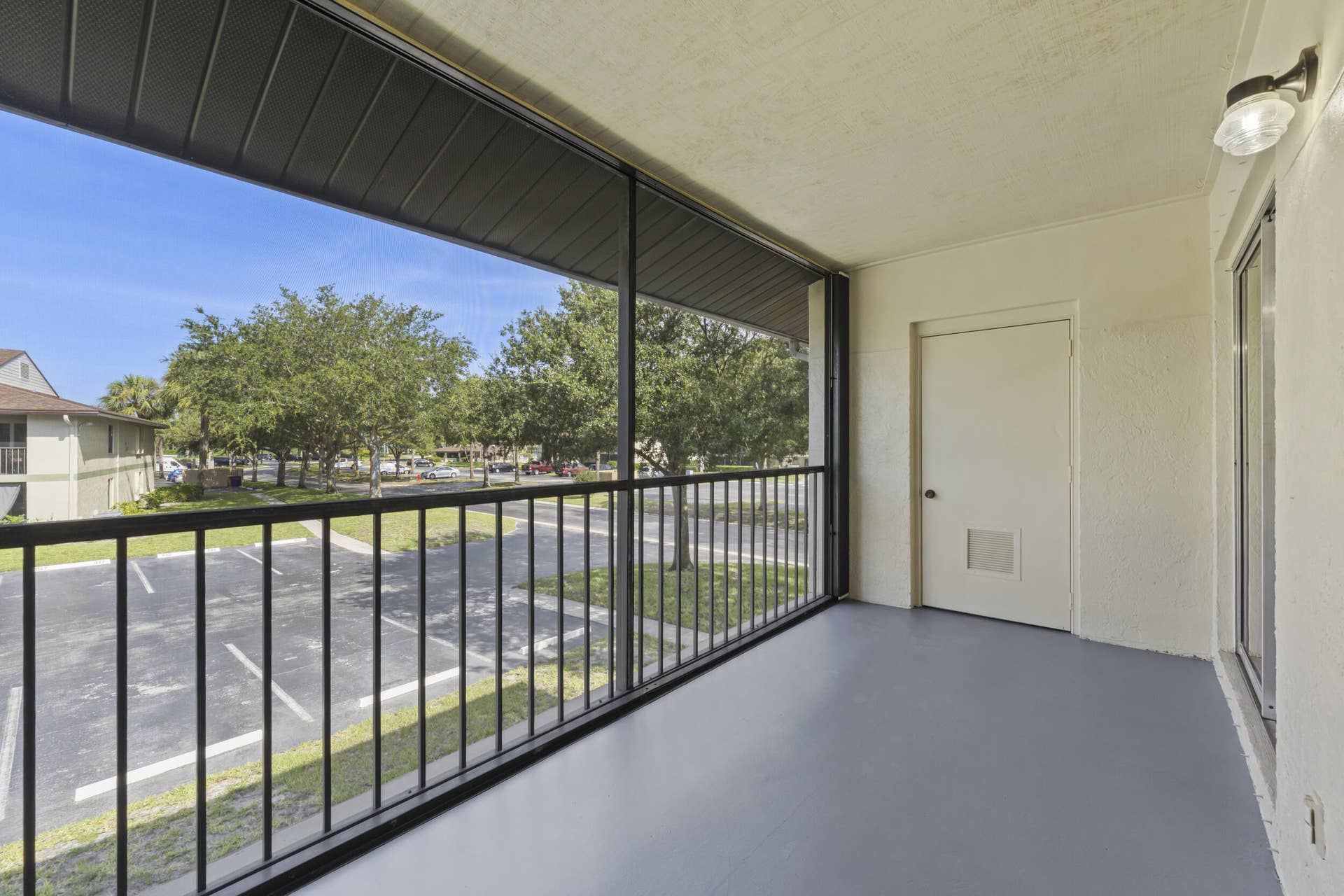 6314 Chasewood Drive, #E, Jupiter, FL 33458 Screen balcony - new screens, accordion shutters and storage closet