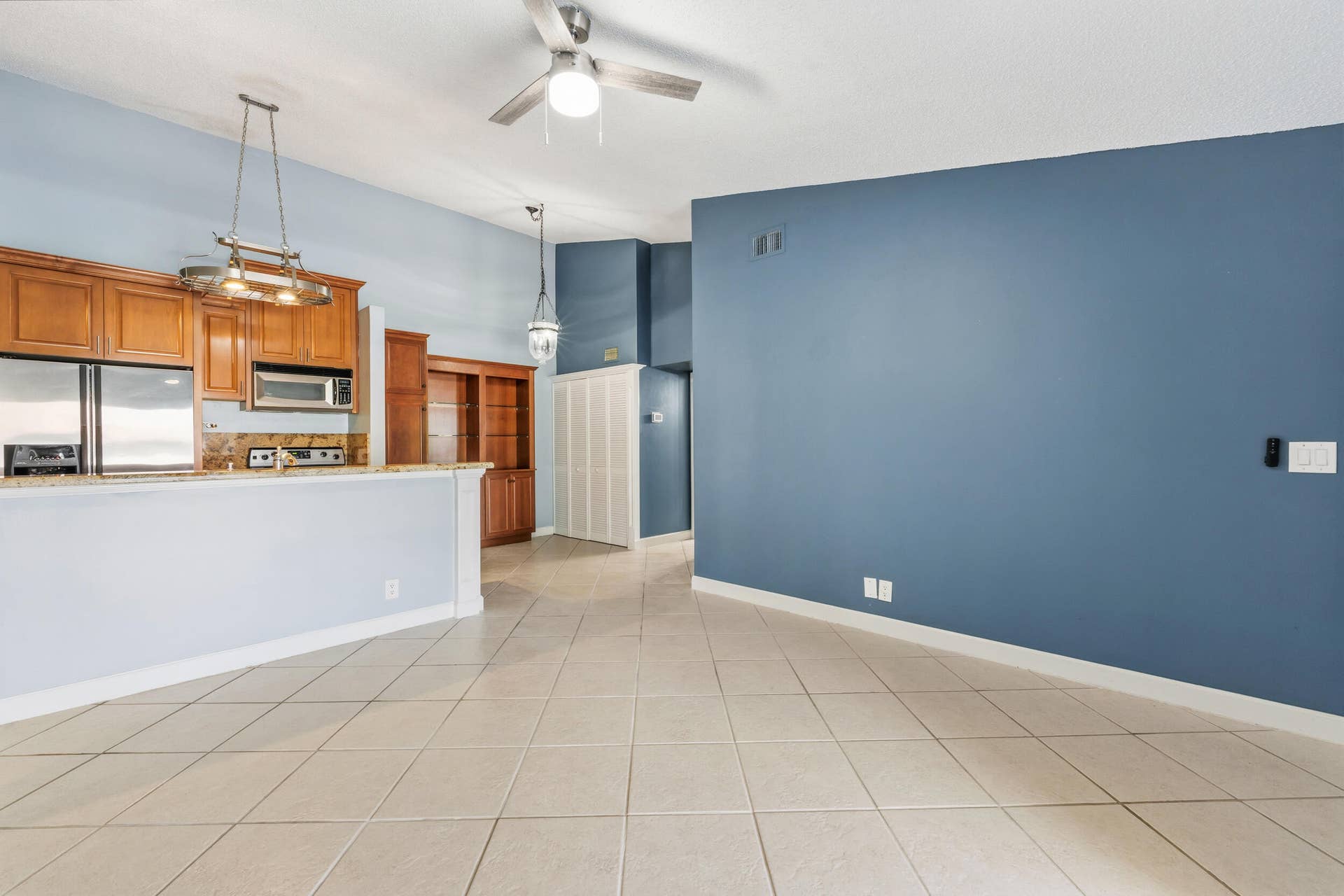 6314 Chasewood Drive, #E, Jupiter, FL 33458 Living area open to the kitchen and dining area.
