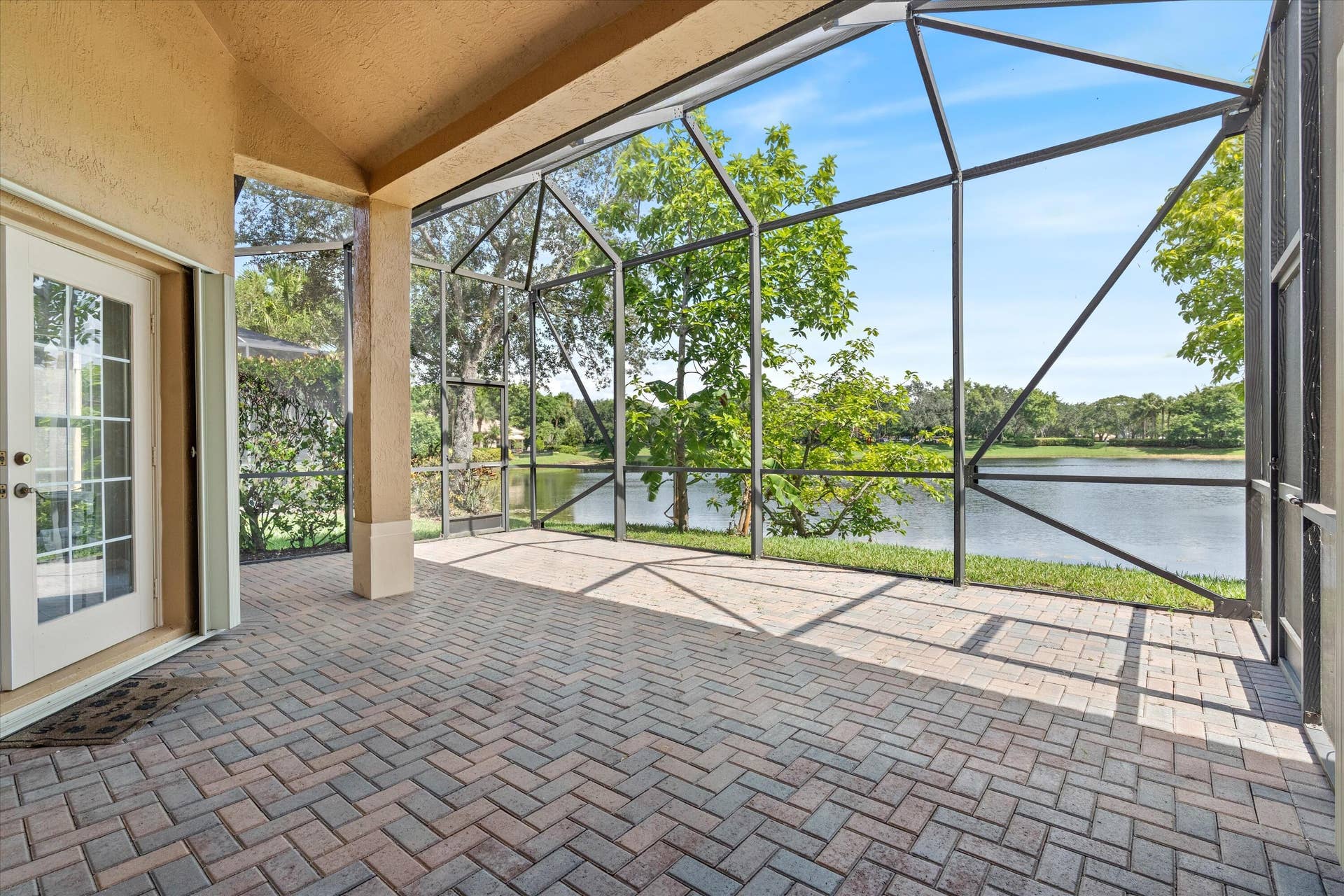 11259 NW 65th Manor, Parkland, FL 33076 03-screened-patio-waterfront-11259-nw-65