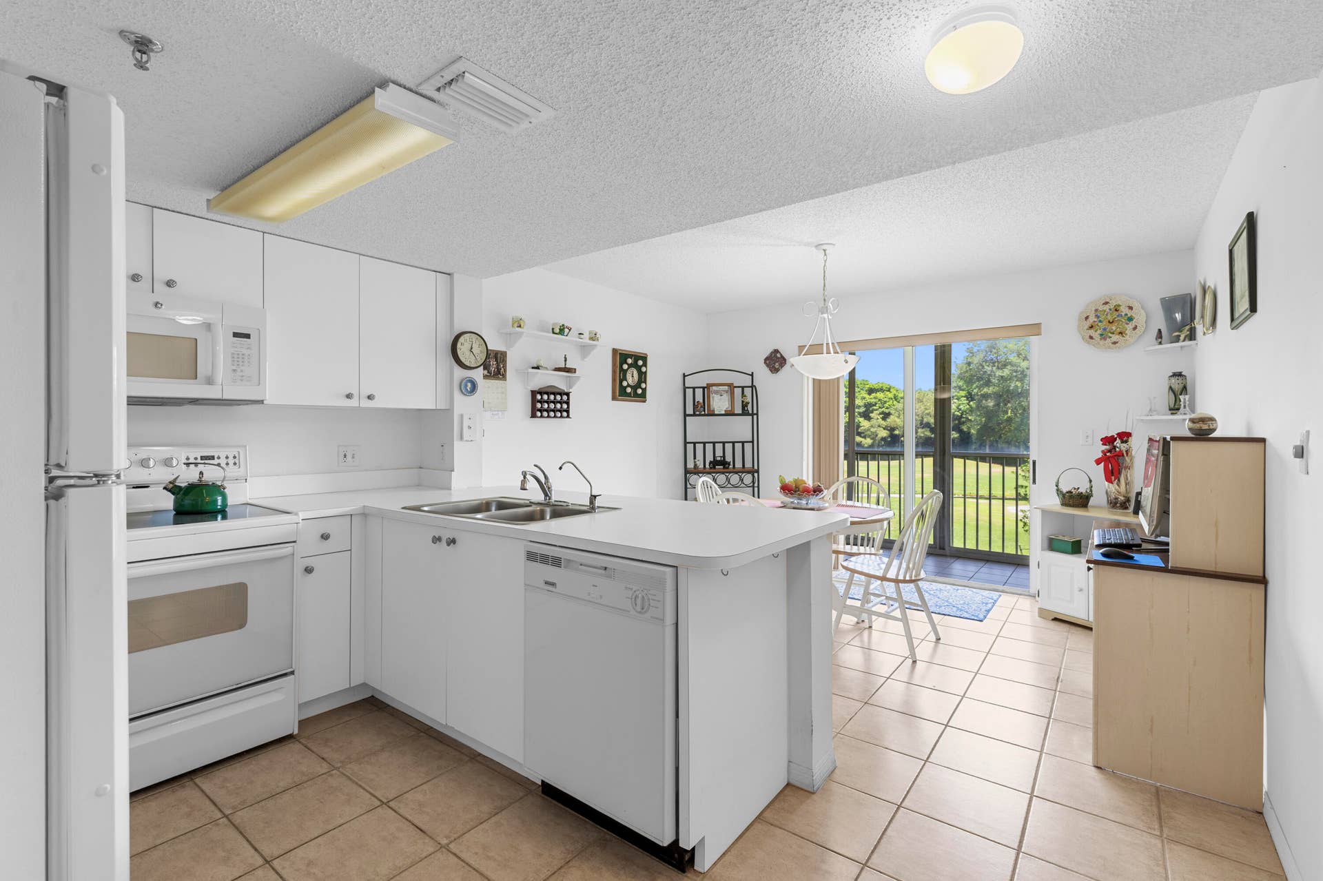 Spacious all-white kitchen in pristine condition