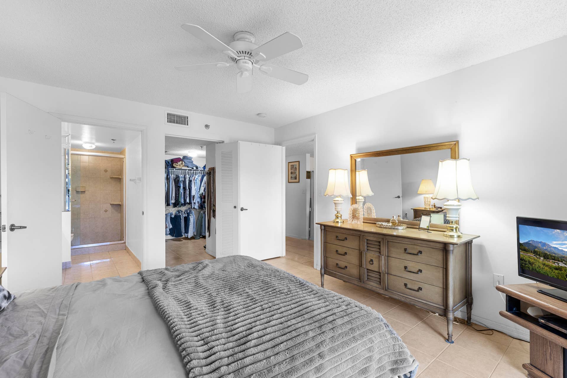 Primary bedroom with on suite bathroom and walk in closet - also sliders to covered/ screened patio