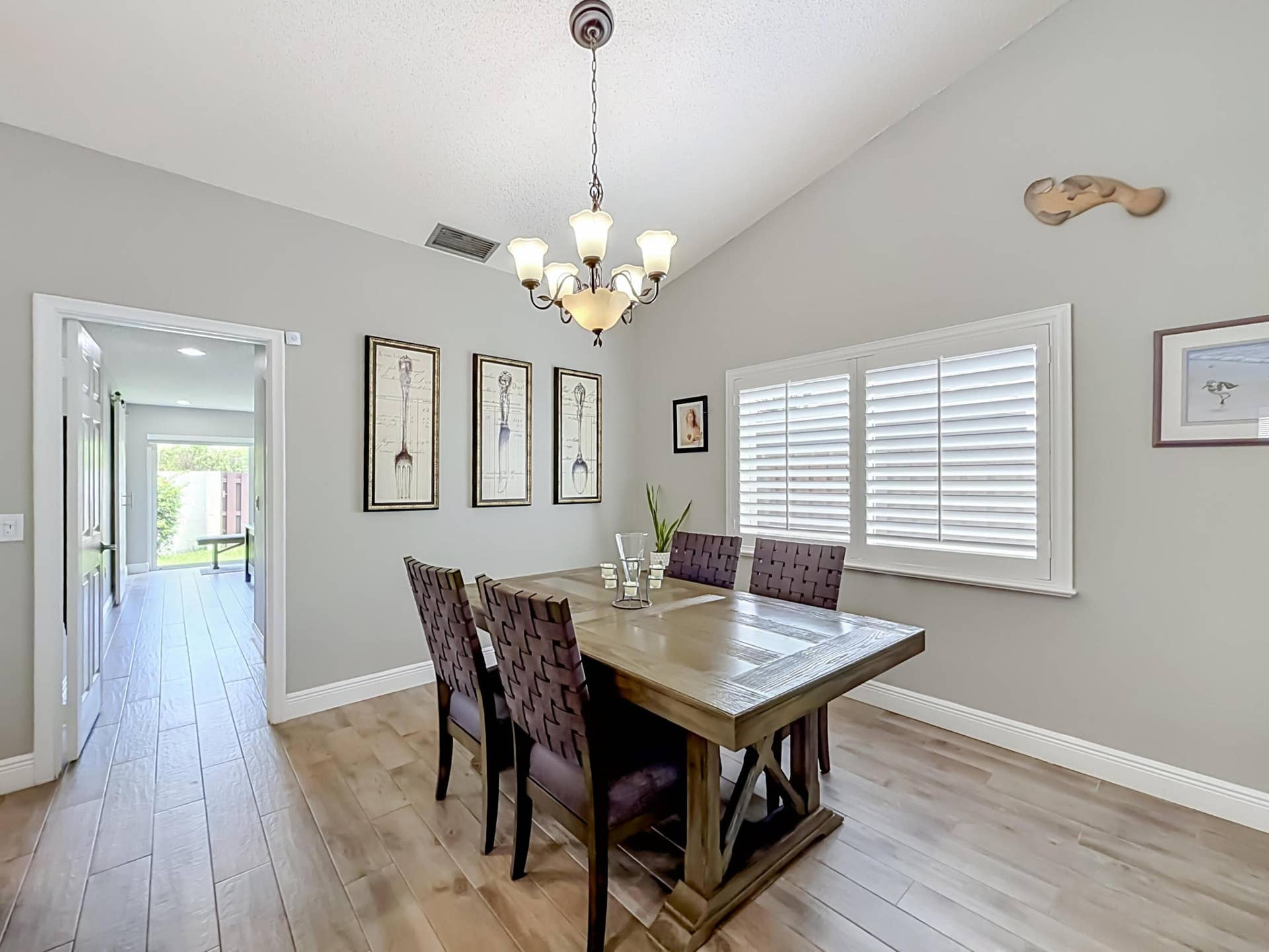 16751 Redwood Way, Weston, FL 33326 Dining area, side yard view, plantation shutters, vaulted ceilings, entrance to primary