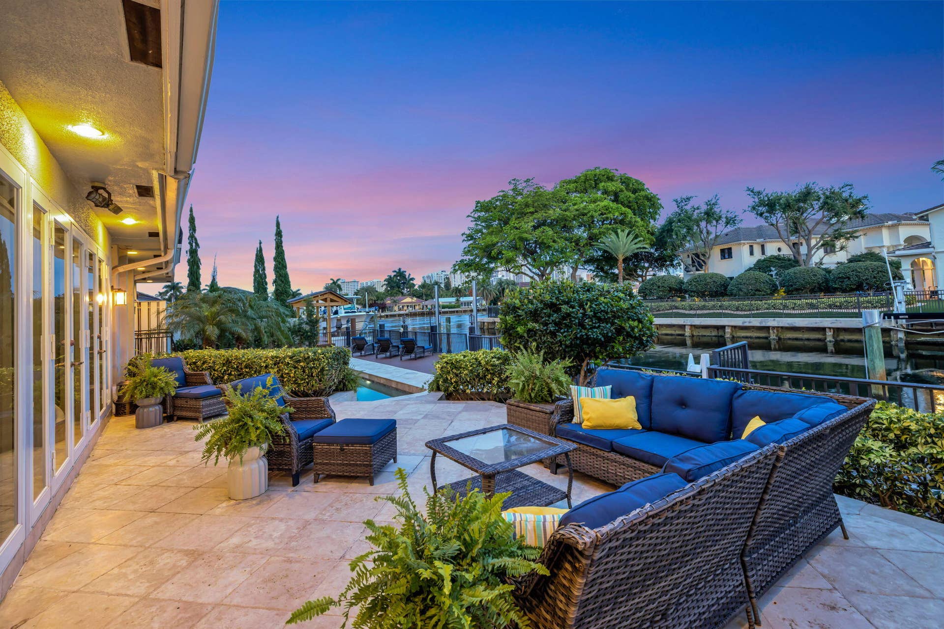 3110 NE 47th Street, Fort Lauderdale, FL 33308 At twilight, the waterfront patio becomes an inviting outdoor entertaining space with dramatic evening color.