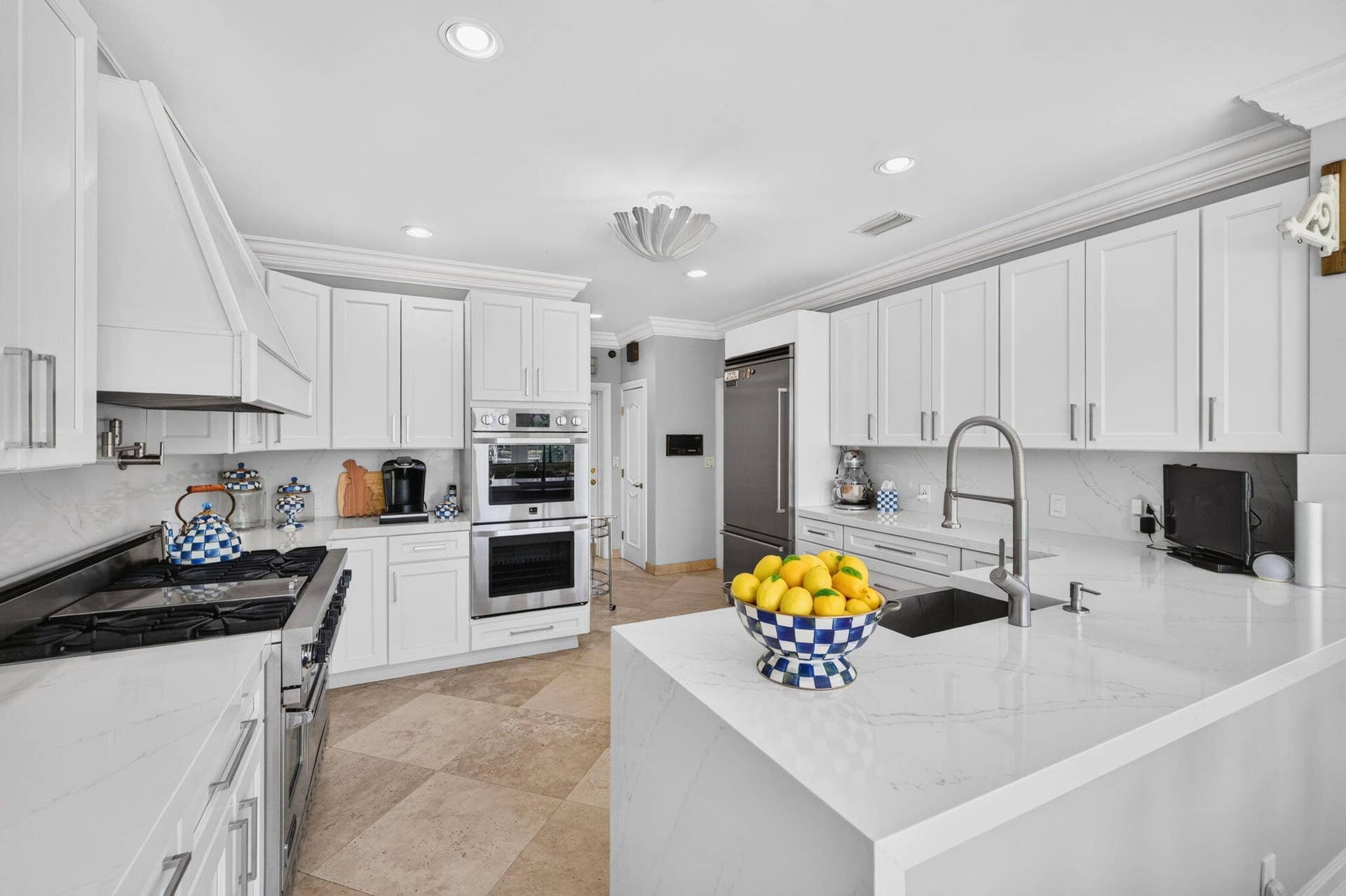 3110 NE 47th Street, Fort Lauderdale, FL 33308 A central island anchors the kitchen with generous prep space, clean finishes, and strong functionality.