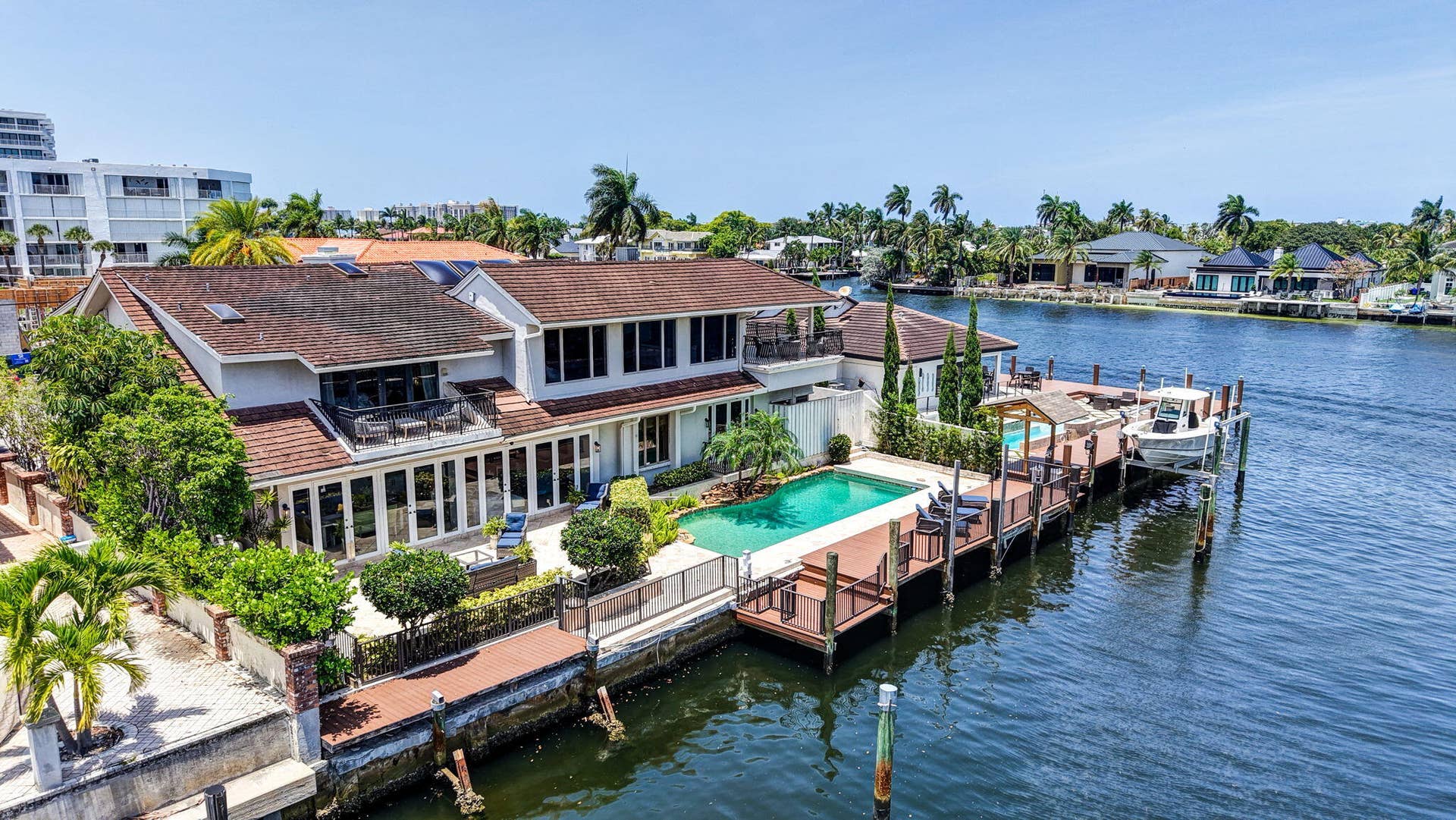 3110 NE 47th Street, Fort Lauderdale, FL 33308 This aerial view shows the homes rear elevation, pool, dock, and direct relationship to the canal.