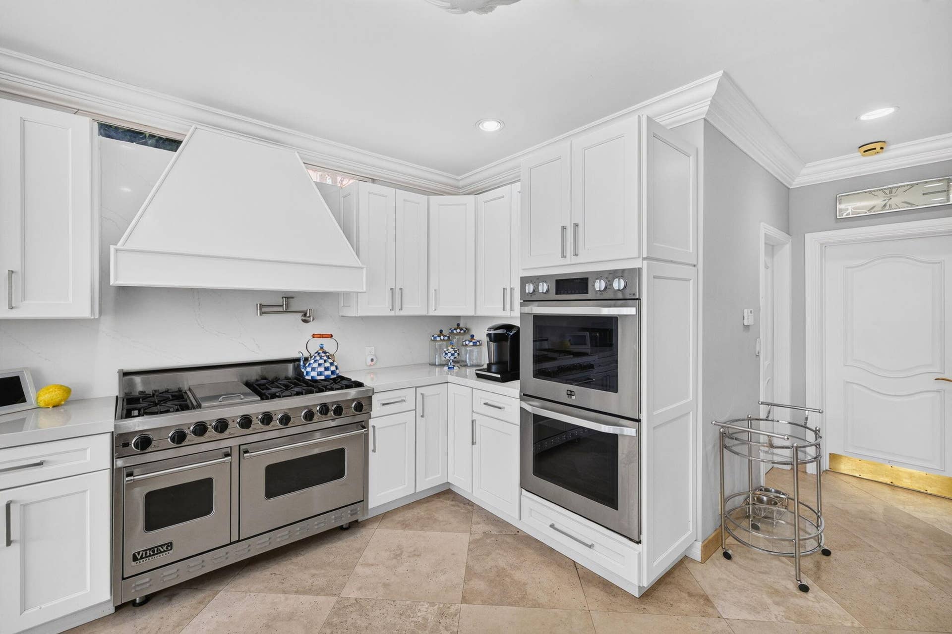 3110 NE 47th Street, Fort Lauderdale, FL 33308 The kitchens range wall and built-in appliances provide a crisp, organized workspace for cooking and hosting.