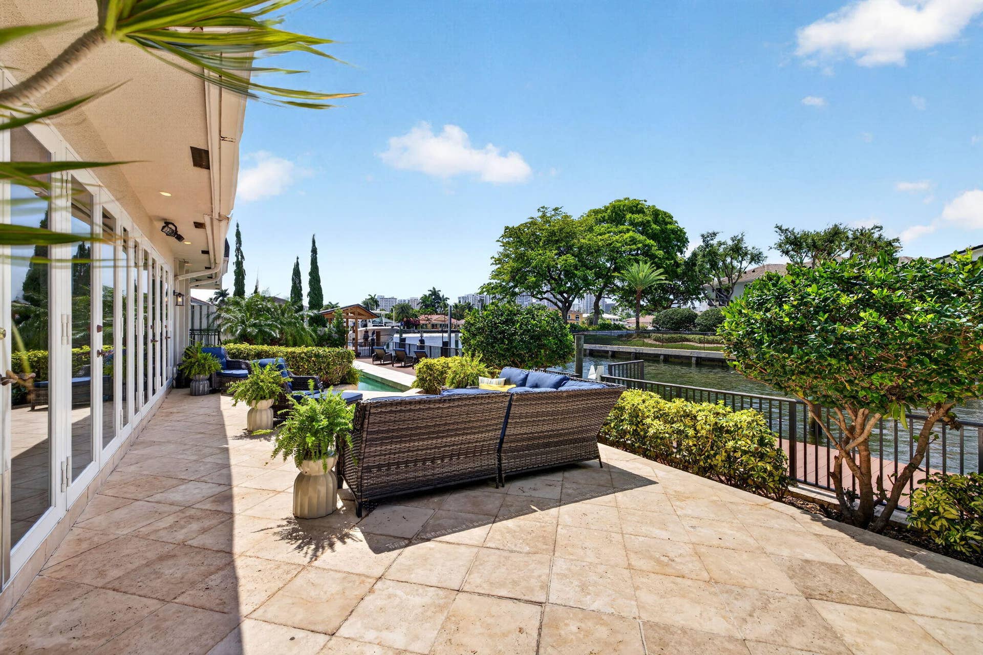 3110 NE 47th Street, Fort Lauderdale, FL 33308 The terrace offers a comfortable outdoor lounge area overlooking the canal and tropical landscaping.
