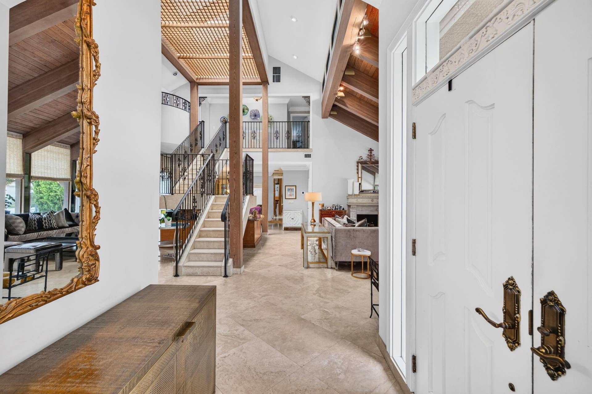 3110 NE 47th Street, Fort Lauderdale, FL 33308 The foyer opens into a dramatic interior with soaring ceilings, architectural detail, and immediate sightlines into the main living areas.