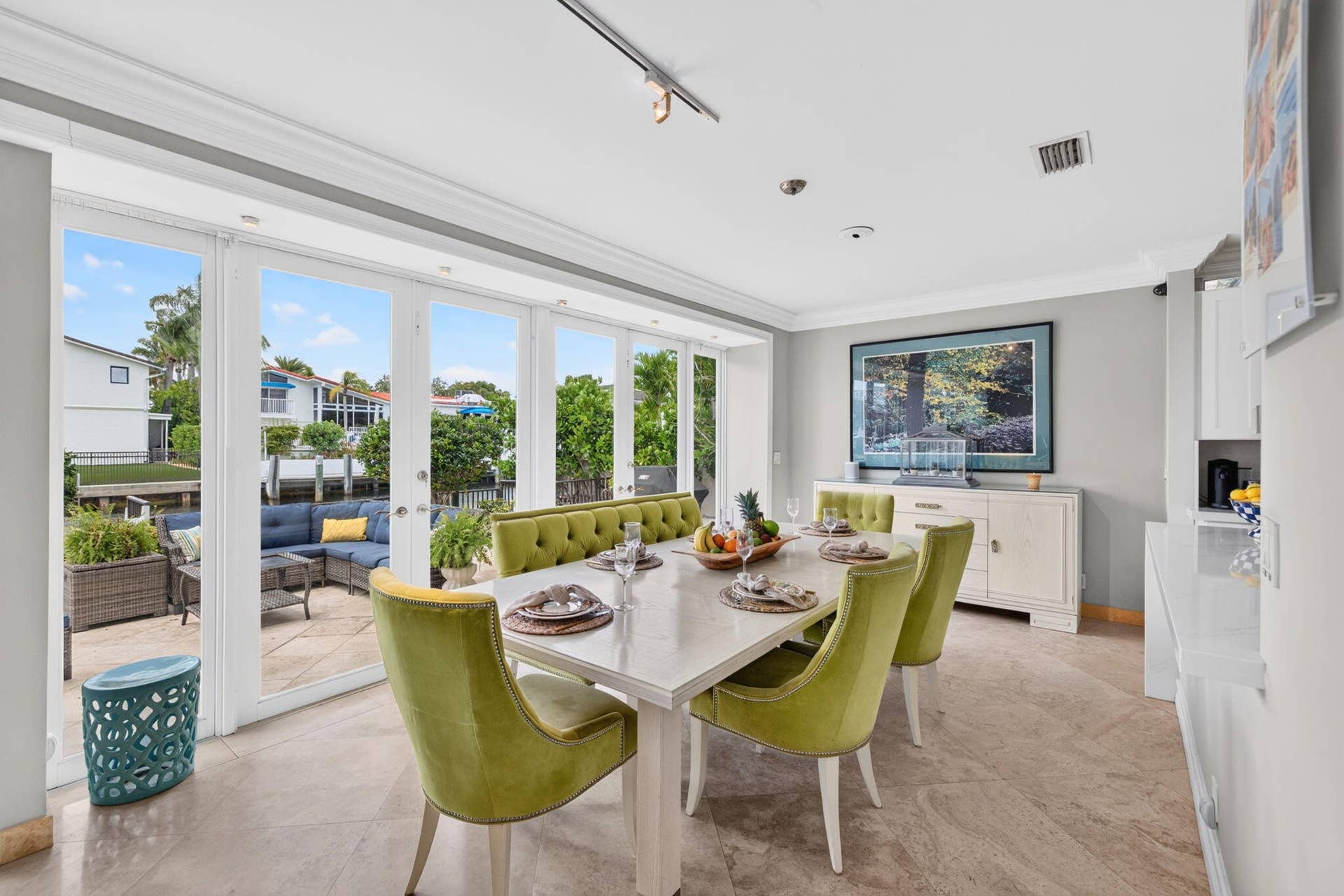 3110 NE 47th Street, Fort Lauderdale, FL 33308 The breakfast area captures canal views through large glass doors, blending everyday dining with the waterfront lifestyle.
