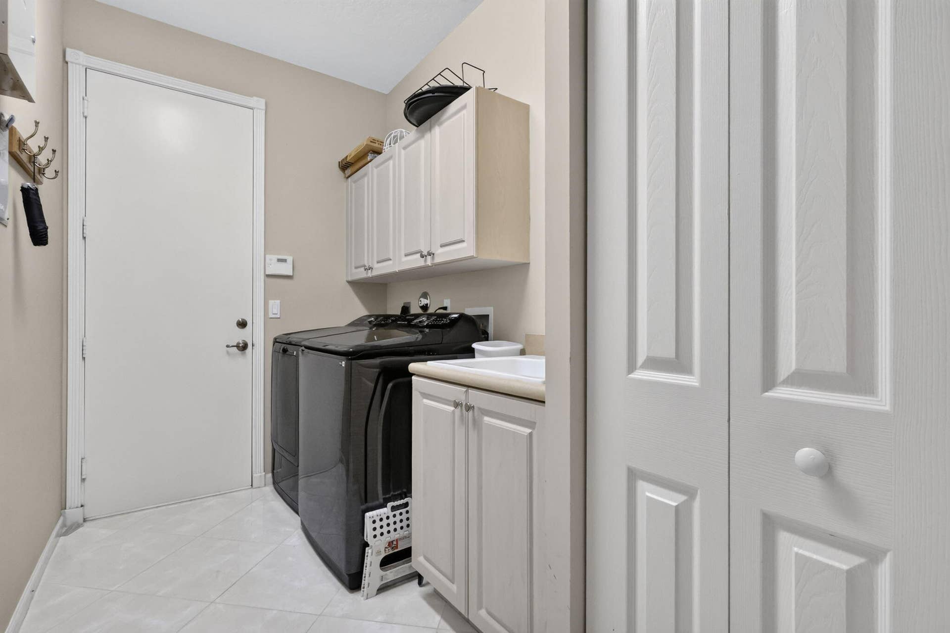 Newer Washer and Dryer. Convenient Sink, Closet and Upper Cabinets for you in mind.