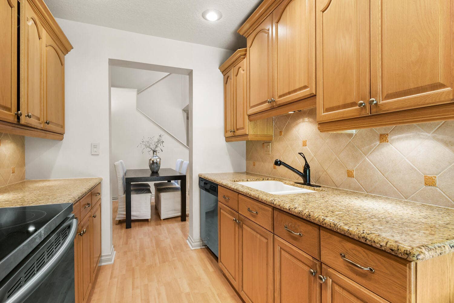 5266 Sapphire Valley, Boca Raton, FL 33486 Beautifully updated kitchen featuring granite countertops, abundant cabinetry, stainless steel appliances, recessed lighting, and direct access to the patio, creating a bright and functional space for everyday living.