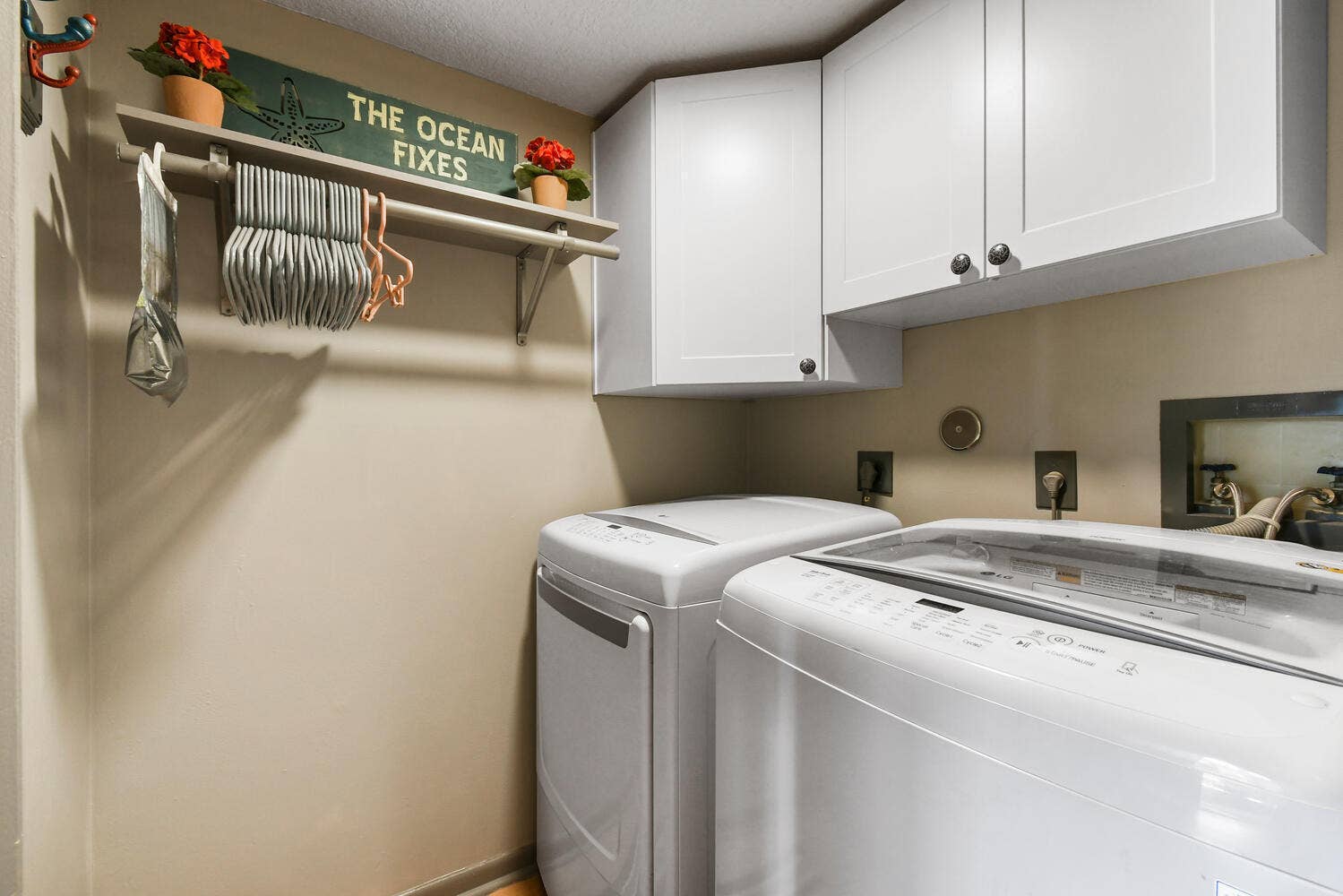 5266 Sapphire Valley, Boca Raton, FL 33486 A dedicated laundry room with full-size washer and dryer, overhead cabinetry for additional storage, and convenient access designed to make everyday household tasks simple and efficient.