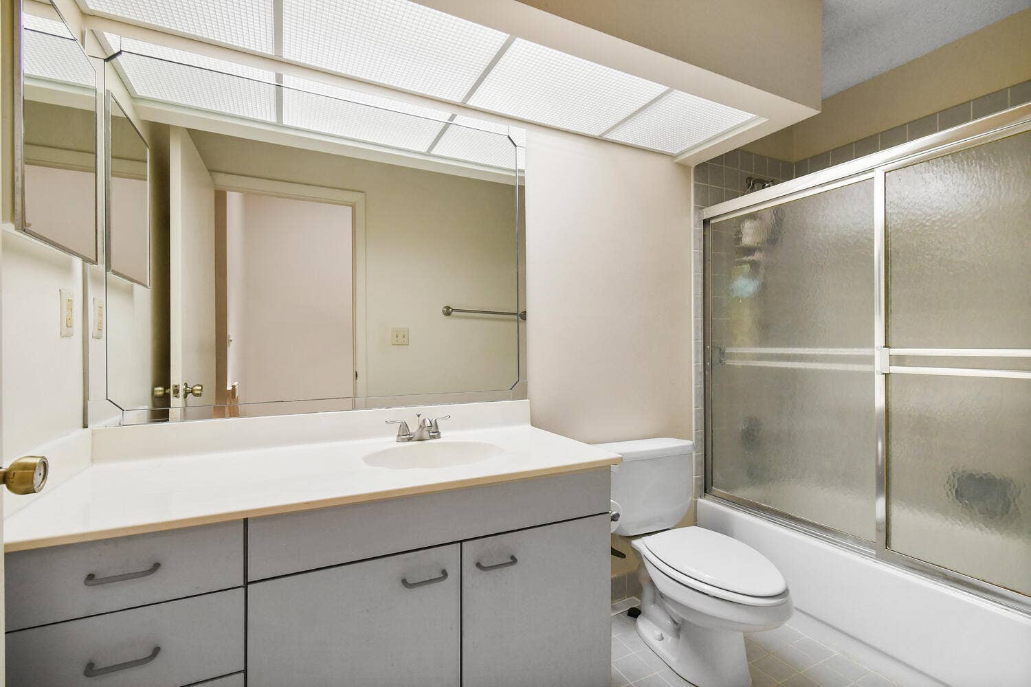 5266 Sapphire Valley, Boca Raton, FL 33486 Bright and functional full bathroom featuring an oversized vanity with generous storage, a full tub and shower combination, and a large skylight that fills the space with natural light.