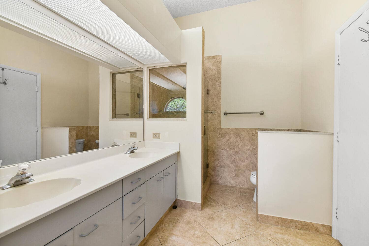 5266 Sapphire Valley, Boca Raton, FL 33486 Spacious ensuite bathroom featuring an oversized dual-sink vanity, abundant storage, a soaking tub, separate shower, and vaulted ceilings. Natural light and an open layout create a bright and relaxing retreat within the primary suite.