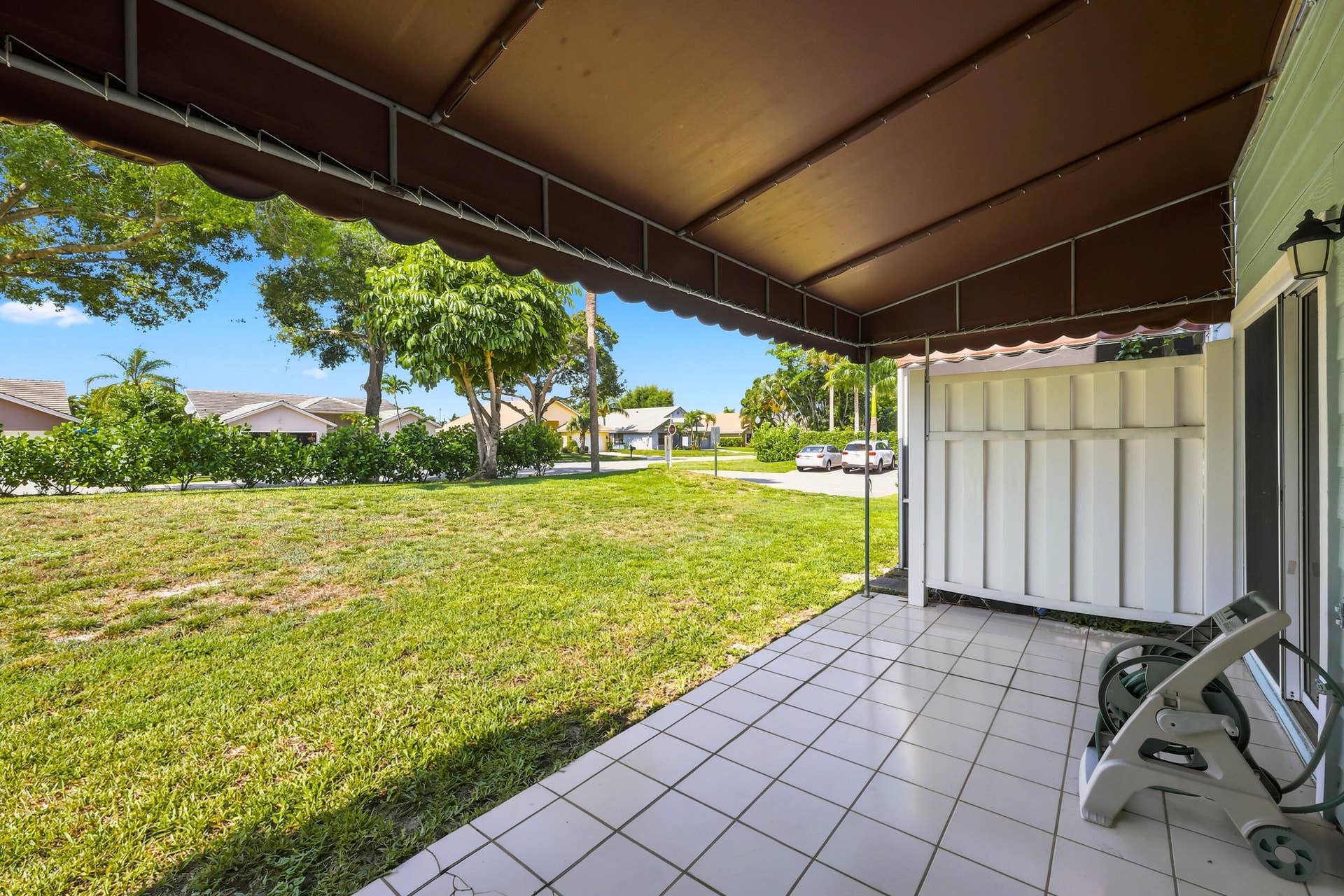 5266 Sapphire Valley, Boca Raton, FL 33486 Enjoy a beautifully maintained green space just beyond your patio, offering a peaceful outdoor setting with mature trees, lush landscaping, and plenty of room to relax and enjoy the Florida sunshine. The desirable corner location creates an open, airy feel and provides attractive garden views rarely found in townhome living.