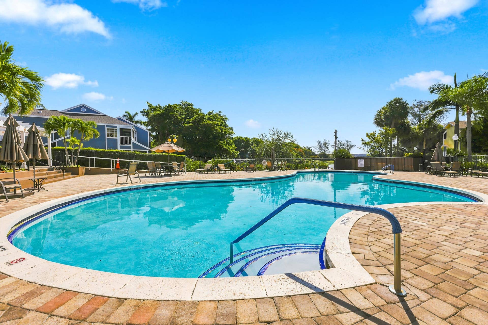 5266 Sapphire Valley, Boca Raton, FL 33486 Resort style community pool surrounded by lush tropical landscaping, offering the perfect place to relax, soak up the South Florida sunshine, or unwind after a day on the course.