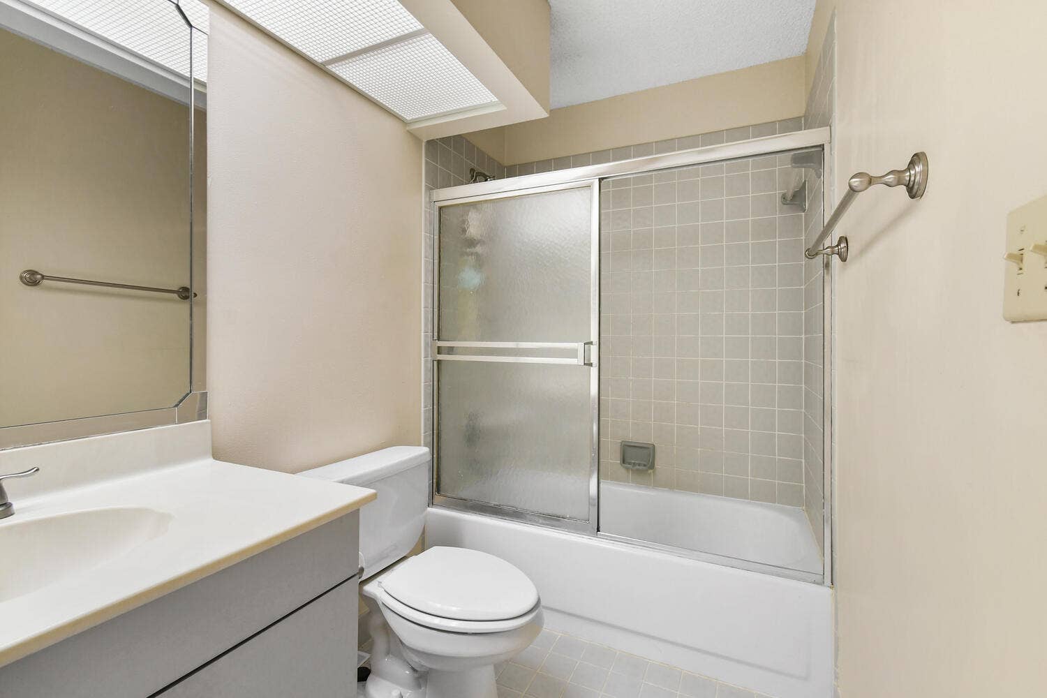 5266 Sapphire Valley, Boca Raton, FL 33486 Bright and functional full bathroom featuring an oversized vanity with generous storage, a full tub and shower combination, and a large skylight that fills the space with natural light.