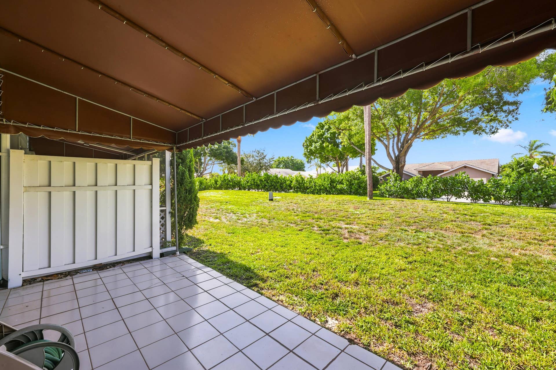 5266 Sapphire Valley, Boca Raton, FL 33486 Enjoy a beautifully maintained green space just beyond your patio, offering a peaceful outdoor setting with mature trees, lush landscaping, and plenty of room to relax and enjoy the Florida sunshine. The desirable corner location creates an open, airy feel and provides attractive garden views rarely found in townhome living.