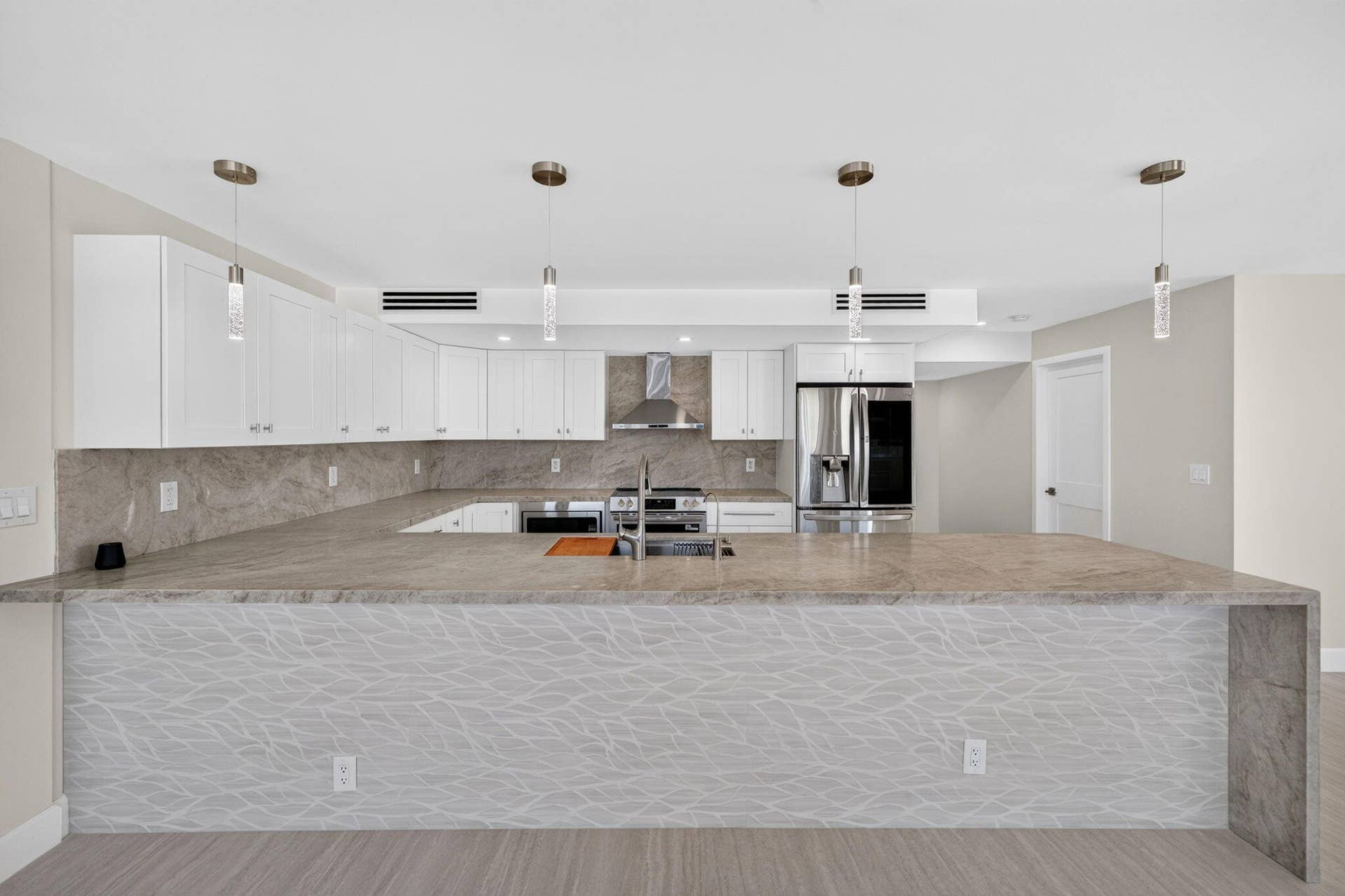 Expansive kitchen with Taj Mahal quartzite countertops