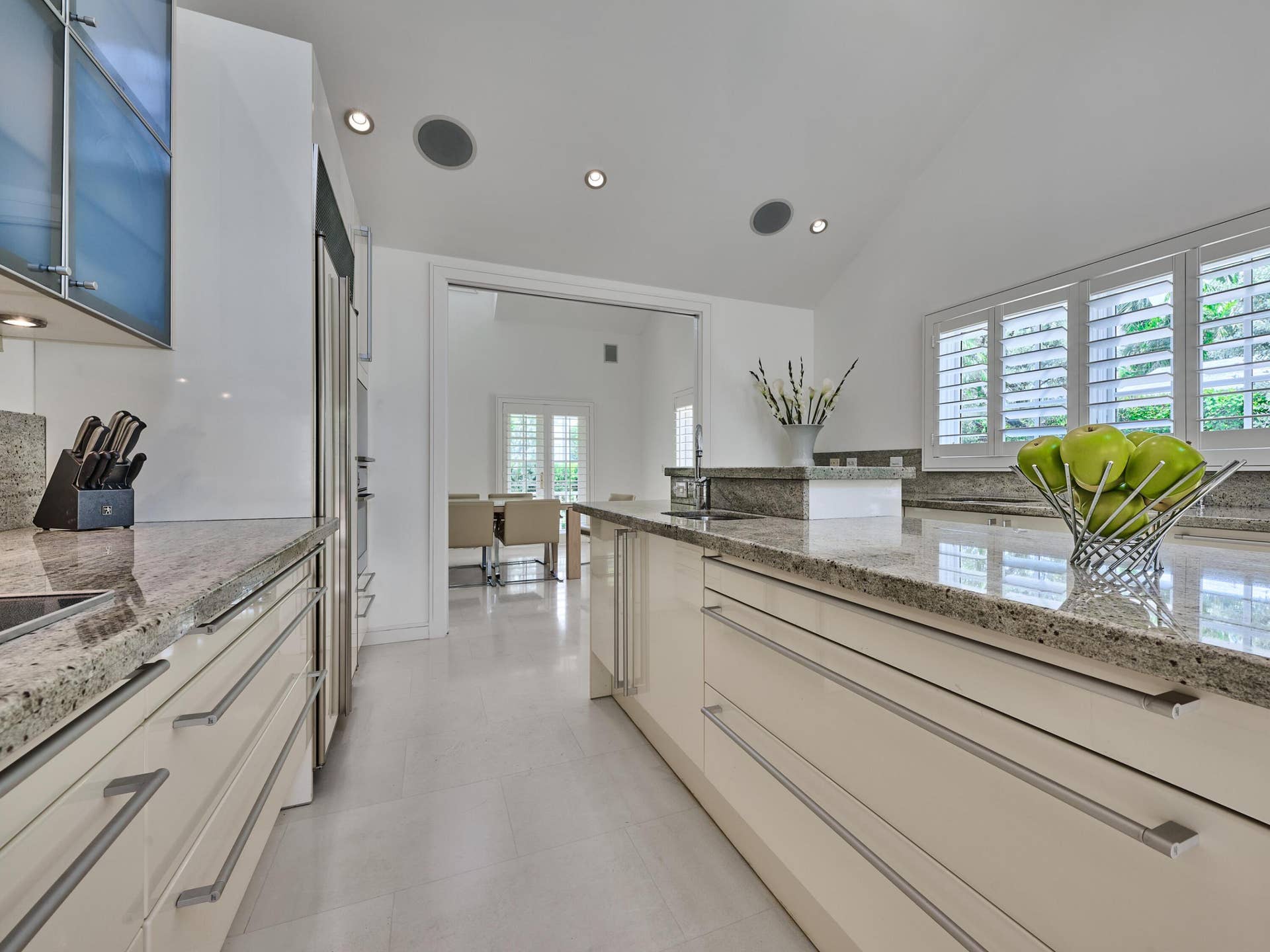 Volume Ceilings, French Doors, Wall of Windows and Dormers bring Natural Light into the Kitchen all day