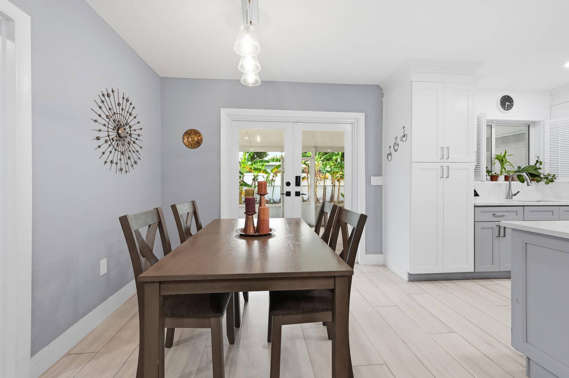 141 SE 8th Street, Pompano Beach, FL 33060 The dining area seamlessly connects the kitchen and screened patio, creating an inviting space for everyday living and entertaining.