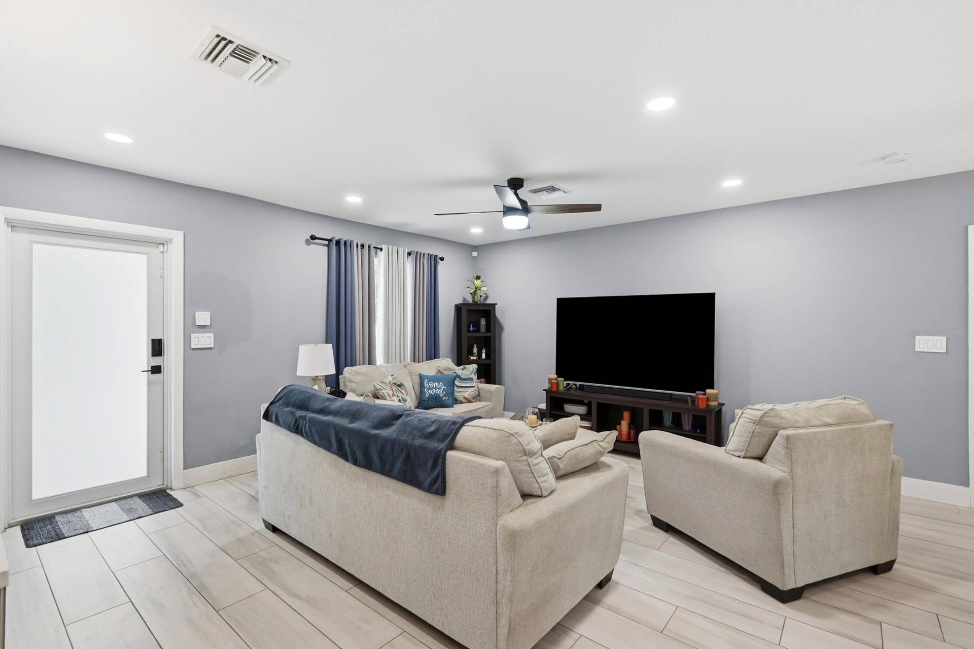 141 SE 8th Street, Pompano Beach, FL 33060 The inviting living room is enhanced by new recessed lighting, adding warmth, style, and a modern touch throughout the home.