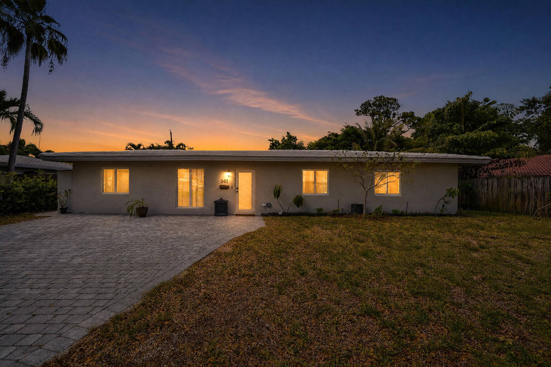 141 SE 8th Street, Pompano Beach, FL 33060 Virtually staged twilight photo showcasing this home's exceptional curb appeal and welcoming evening ambiance.