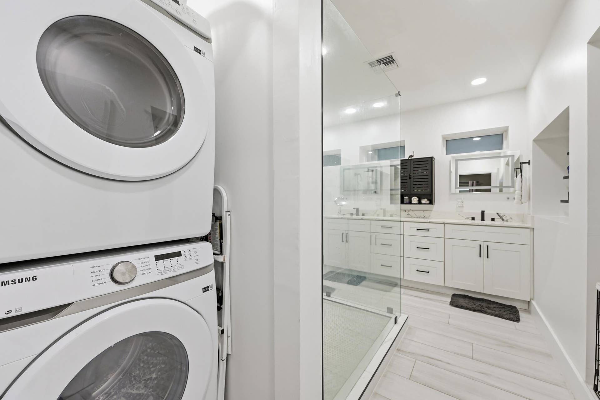 141 SE 8th Street, Pompano Beach, FL 33060 Beautifully renovated primary bathroom with full sized washer and dryer for added everyday convenience.