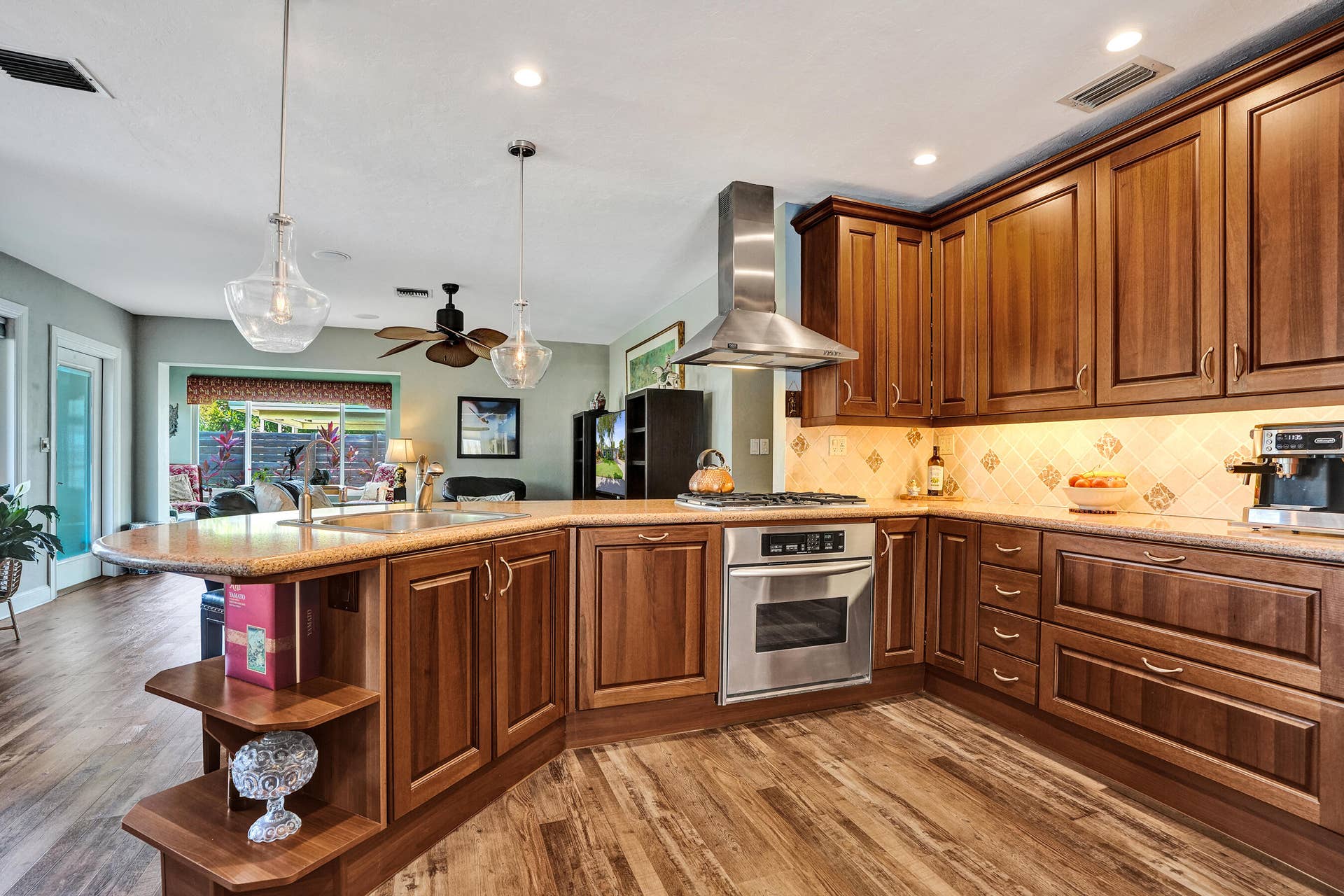 NKBA-designed chef's kitchen featuring ARAN Italian cabinetry, Silestone quartz countertops from Spain, KitchenAid Professional Series stainless appliances, natural gas cooktop, Bosch paneled dishwasher, walk-in pantry, and spacious eat-in peninsula.