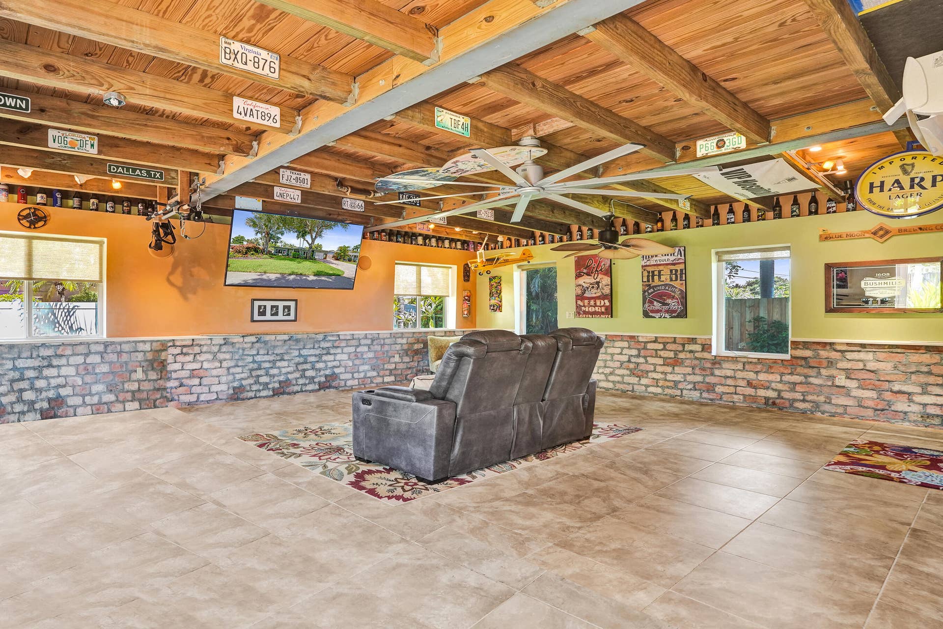 Extraordinary bonus room with tongue-and-groove stained wood ceiling, Chicago brick accents, wet kitchenette, ARAN Italian cabinetry, granite countertops, TV bar, dedicated mini-split A/C, and endless possibilities for media, fitness, or guest accommodations.