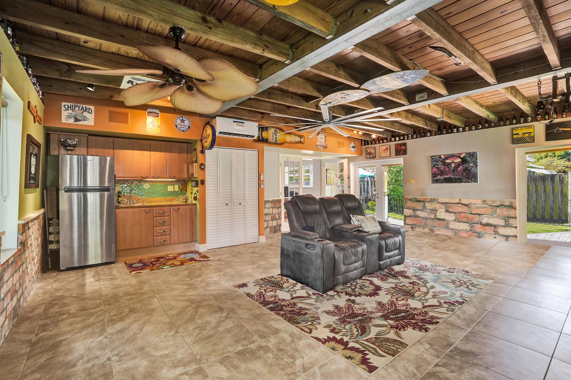 Extraordinary bonus room with tongue-and-groove stained wood ceiling, Chicago brick accents, wet kitchenette, ARAN Italian cabinetry, granite countertops, TV bar, dedicated mini-split A/C, and endless possibilities for media, fitness, or guest accommodations.