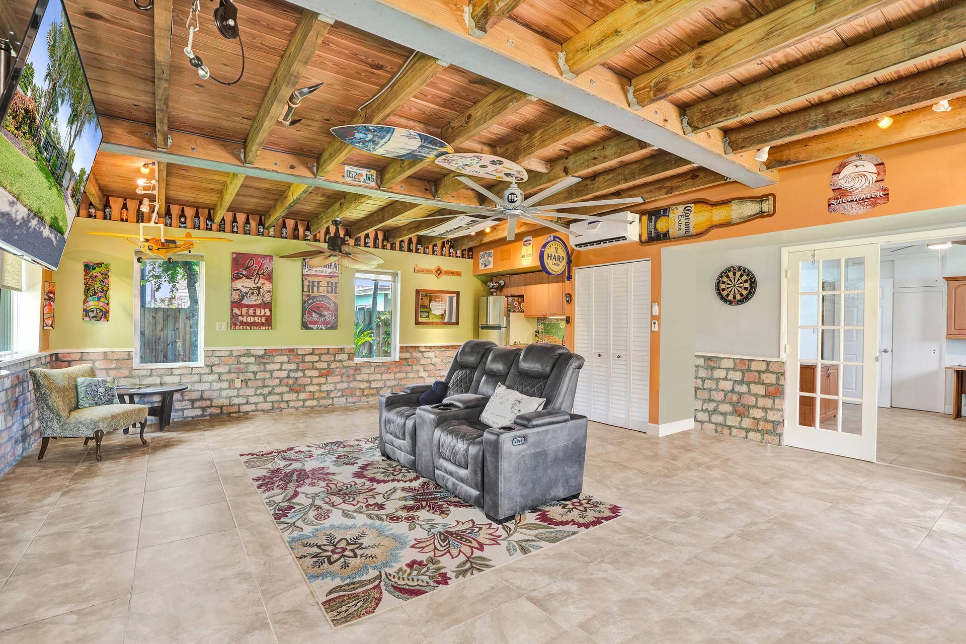 Extraordinary bonus room with tongue-and-groove stained wood ceiling, Chicago brick accents, wet kitchenette, ARAN Italian cabinetry, granite countertops, TV bar, dedicated mini-split A/C, and endless possibilities for media, fitness, or guest accommodations.