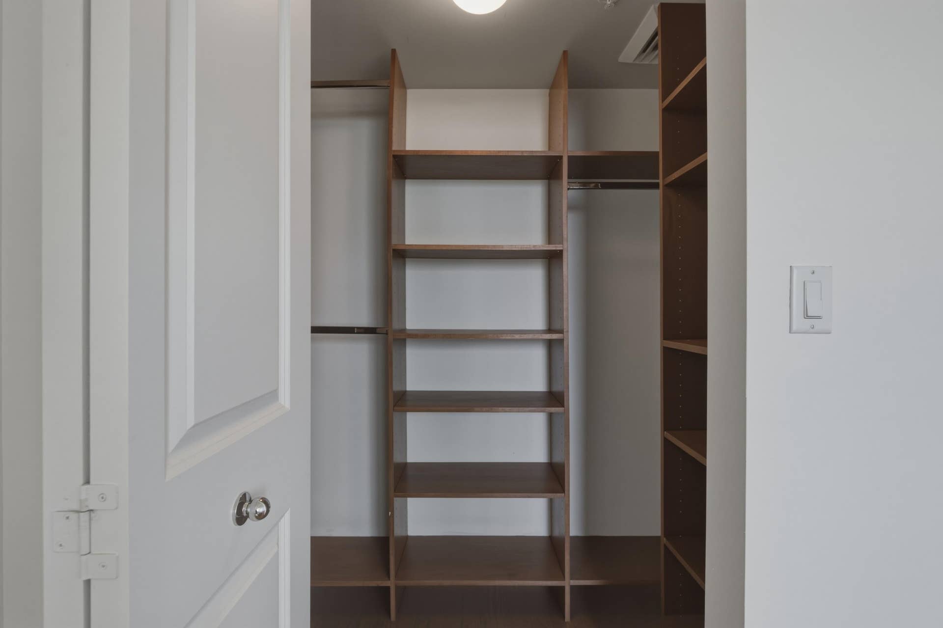Primary Bedroom Walk-In Closet with custom cabinetry