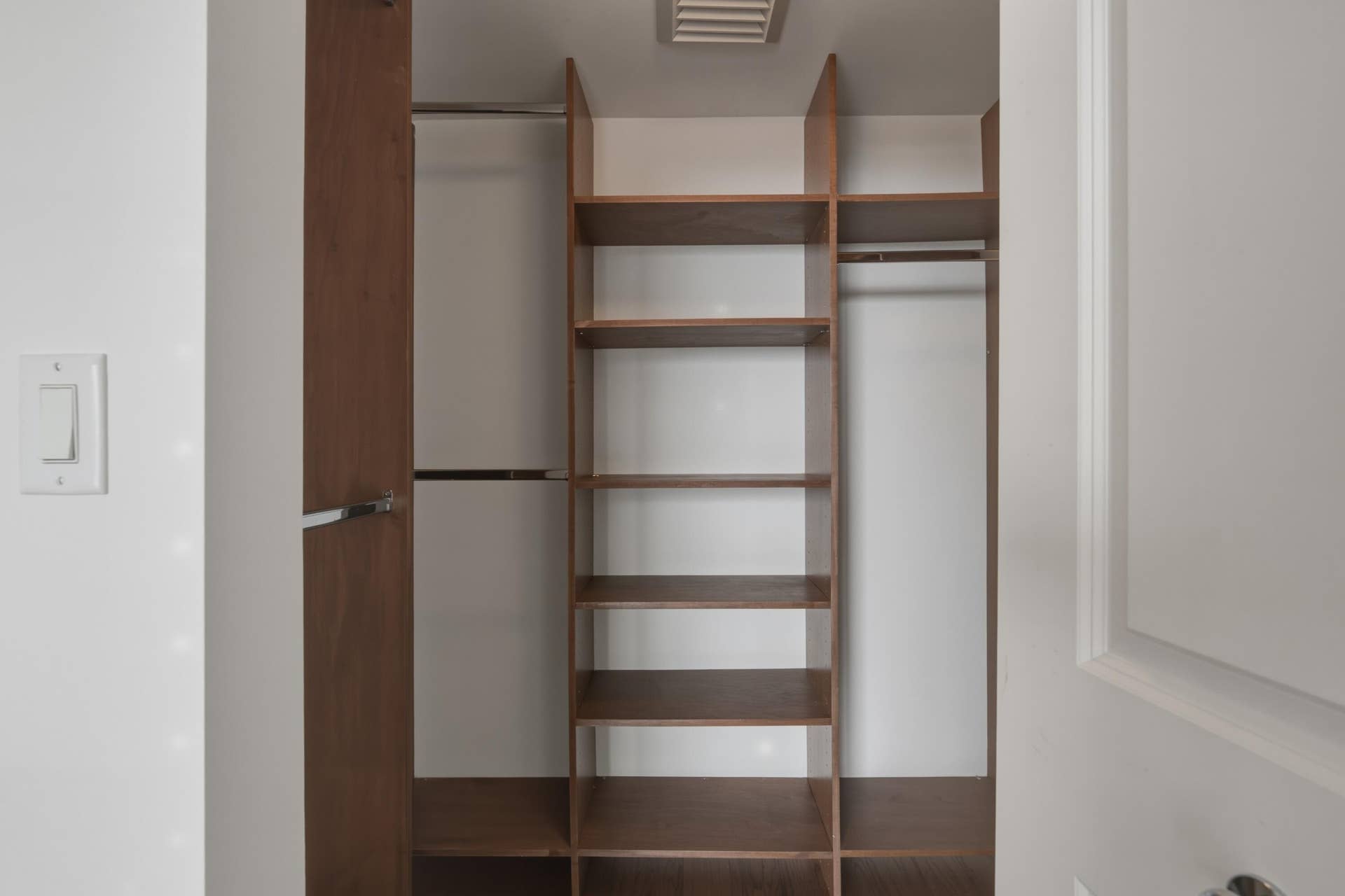Guest Bedroom Walk-In Closet with custom cabinetry