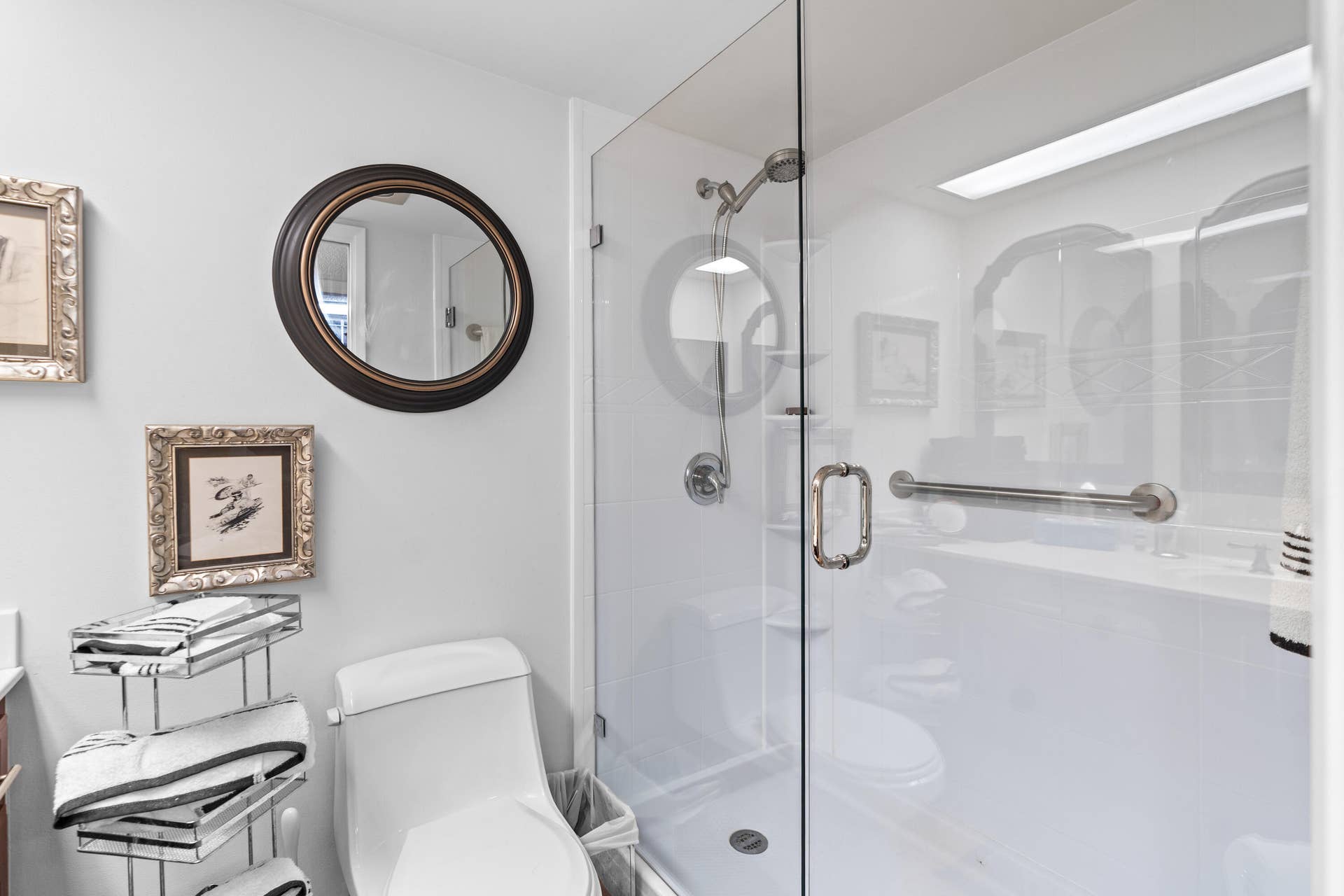 The ensuite bath features a sleek modern frameless glass shower, blending timeless style with everyday comfort.