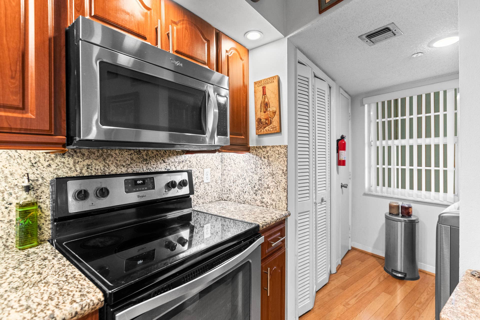 The kitchen features granite countertops, newer stainless steel appliances and a pantry.